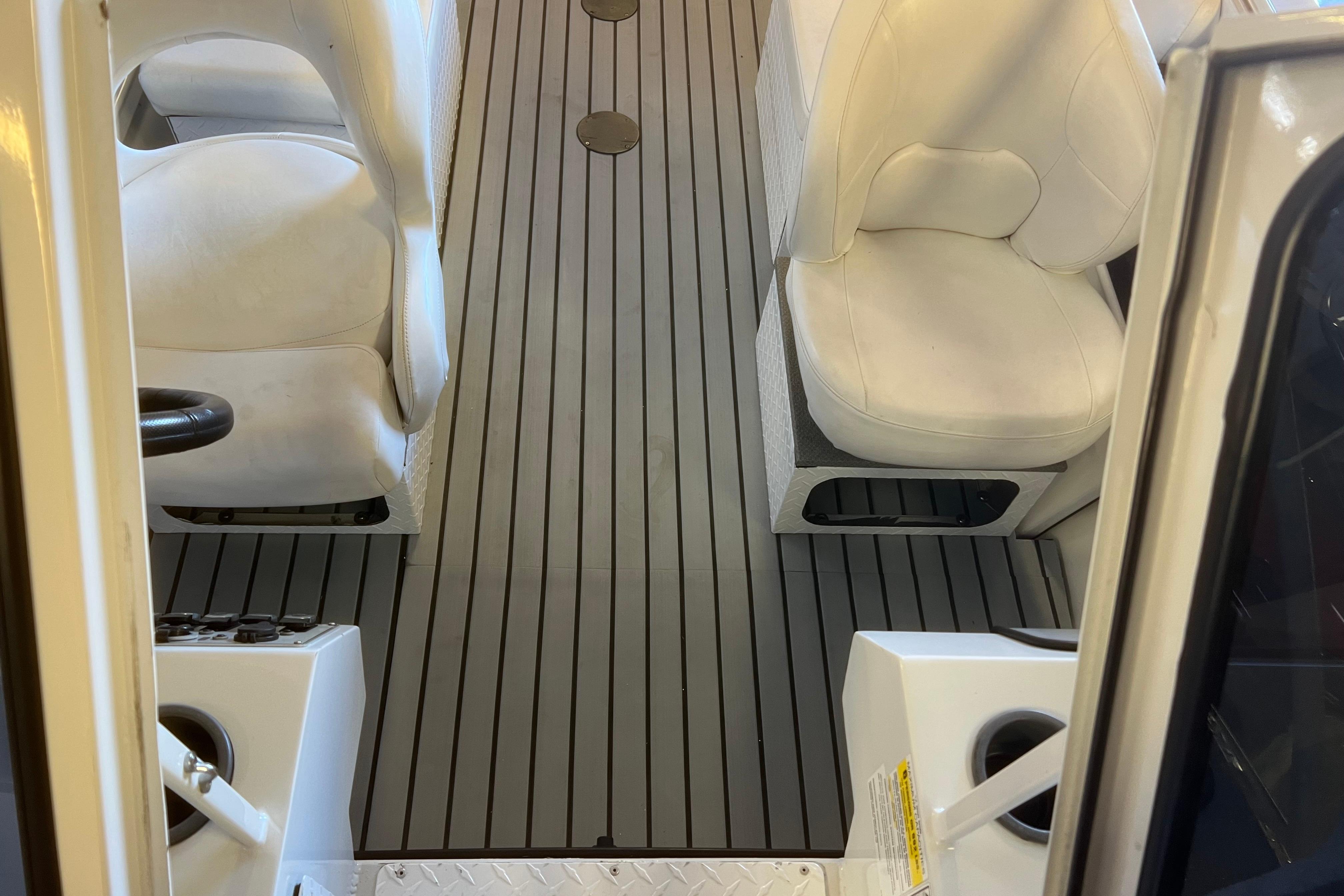 Interior view of 2019 KingFisher 1825 Falcon boat with white seating and striped flooring.