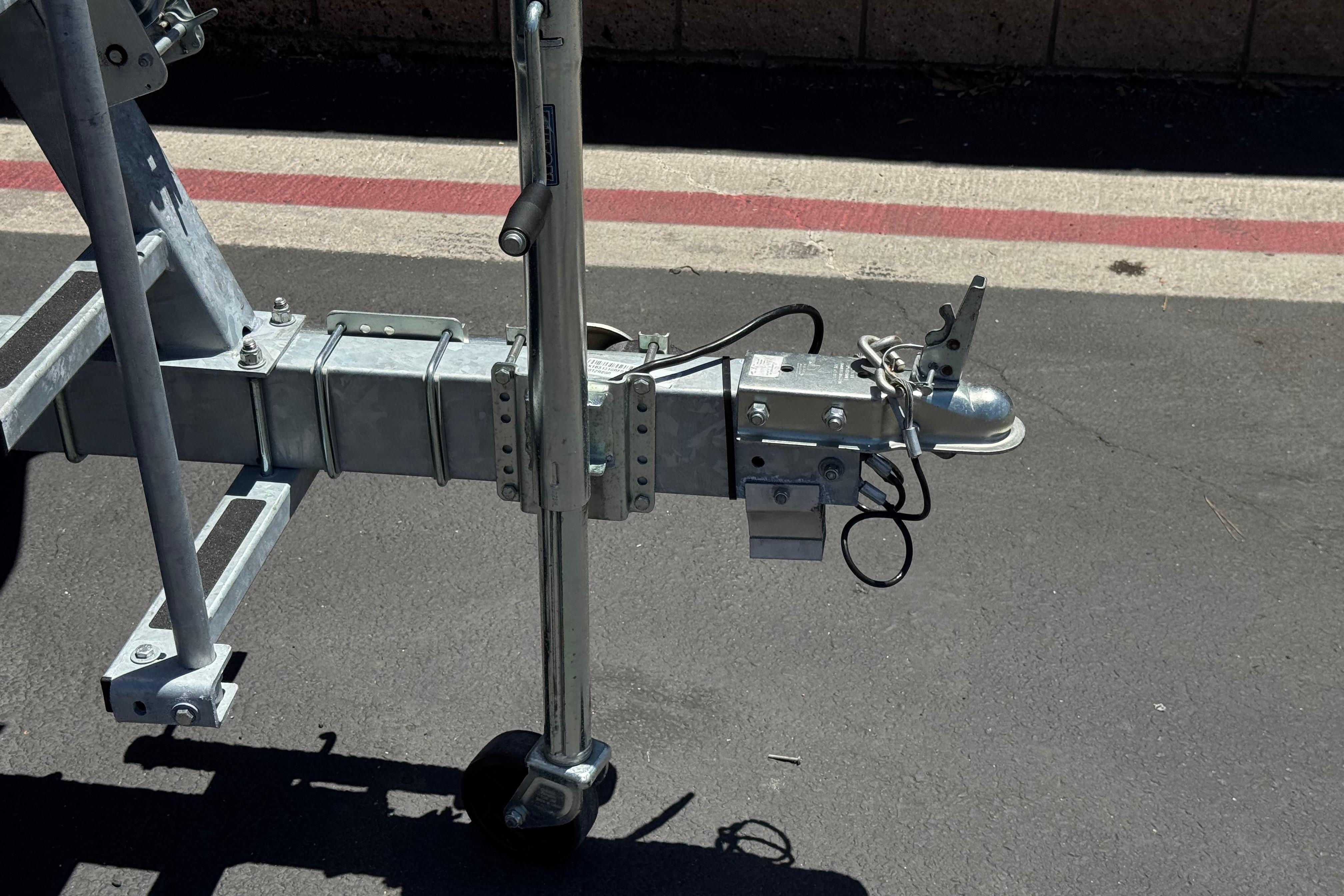 Trailer hitch of a 2024 Sea-Doo Switch Compact on asphalt pavement.
