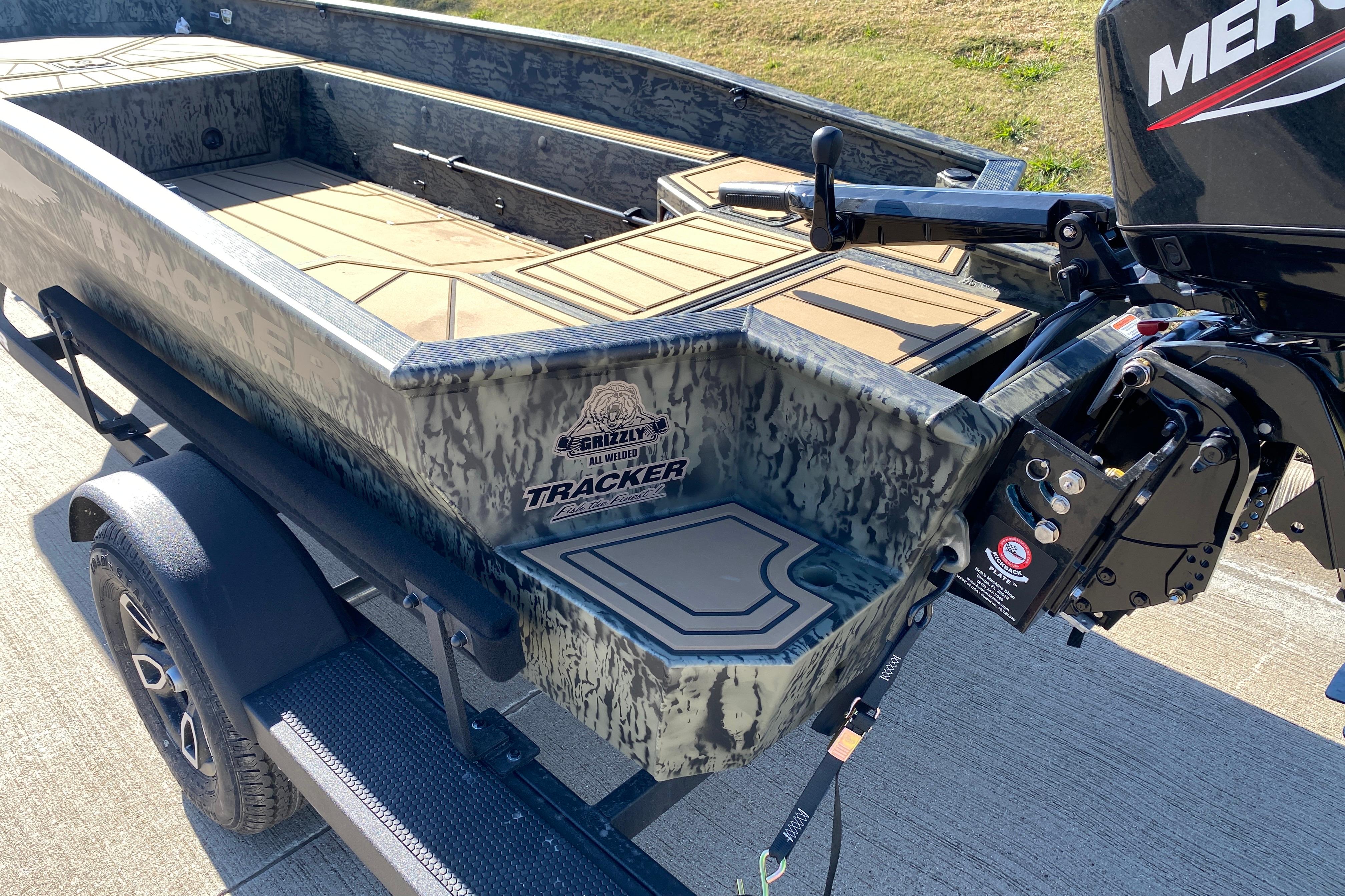 2026 Tracker Grizzly 1650 T Prairie Wings Edition boat with camo design and Mercury engine.