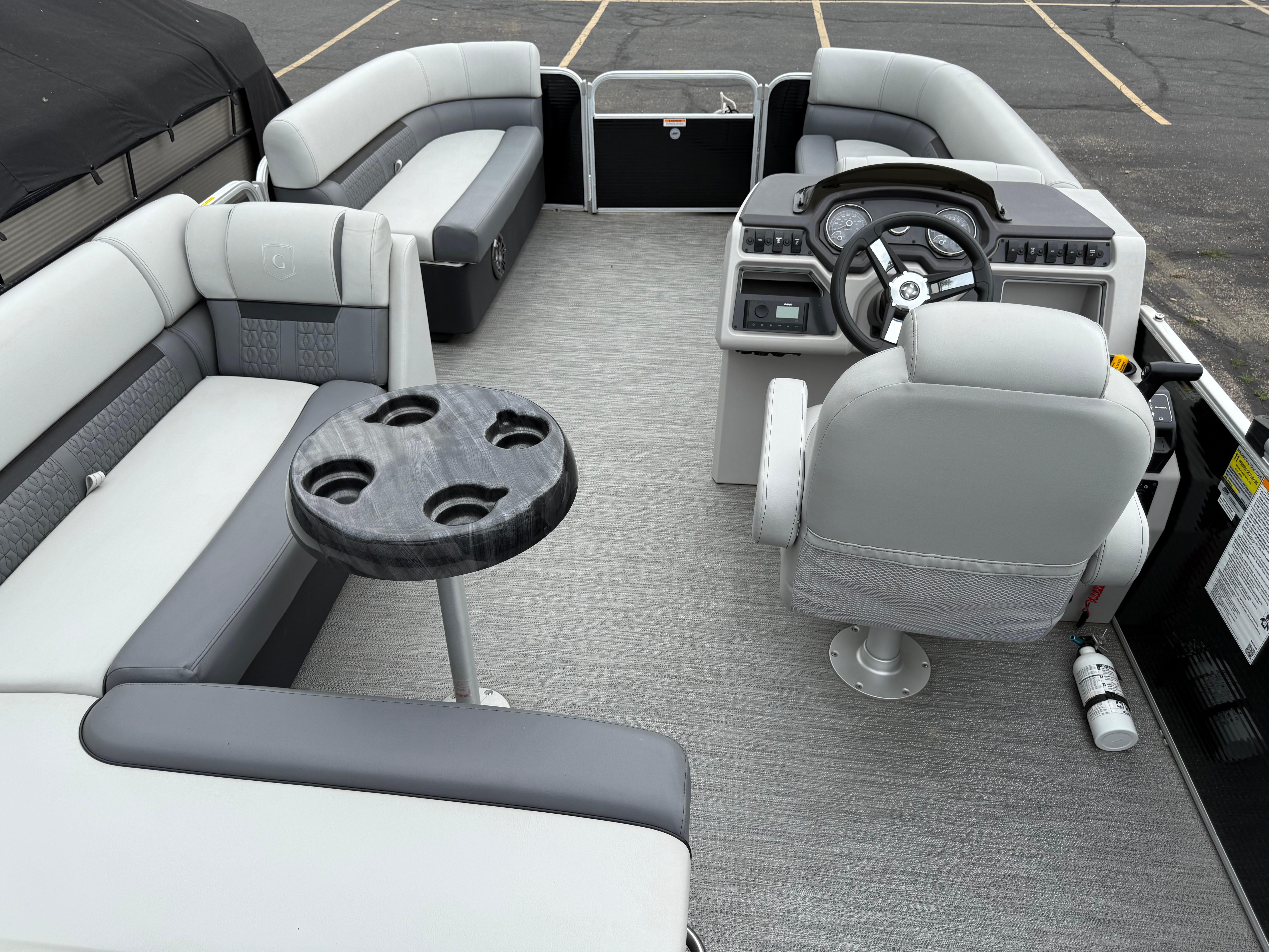 2023 Godfrey Sweetwater pontoon boat interior with gray seating and steering console.