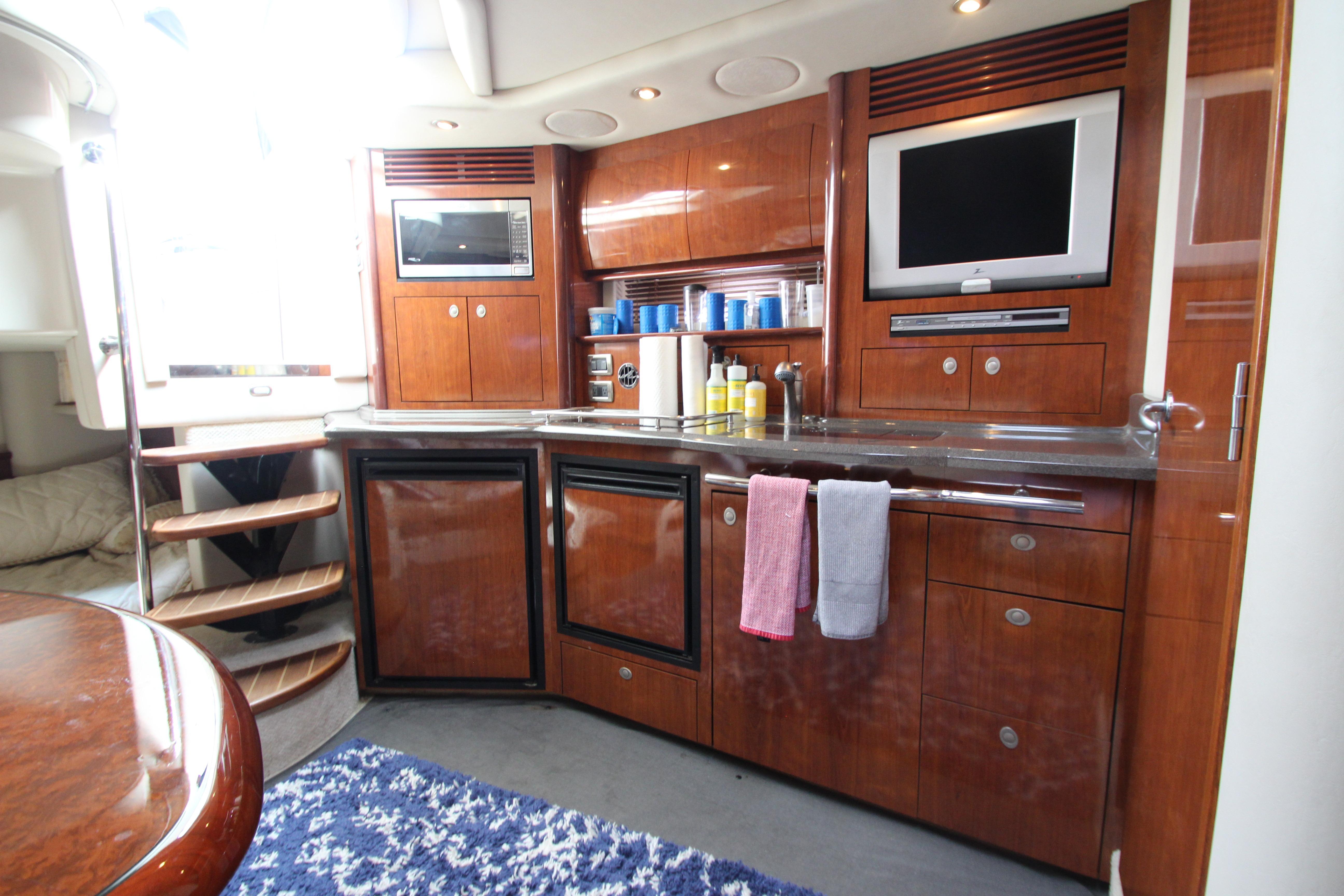 Luxurious 2004 Sea Ray 40 Sundancer yacht interior with modern kitchen amenities.