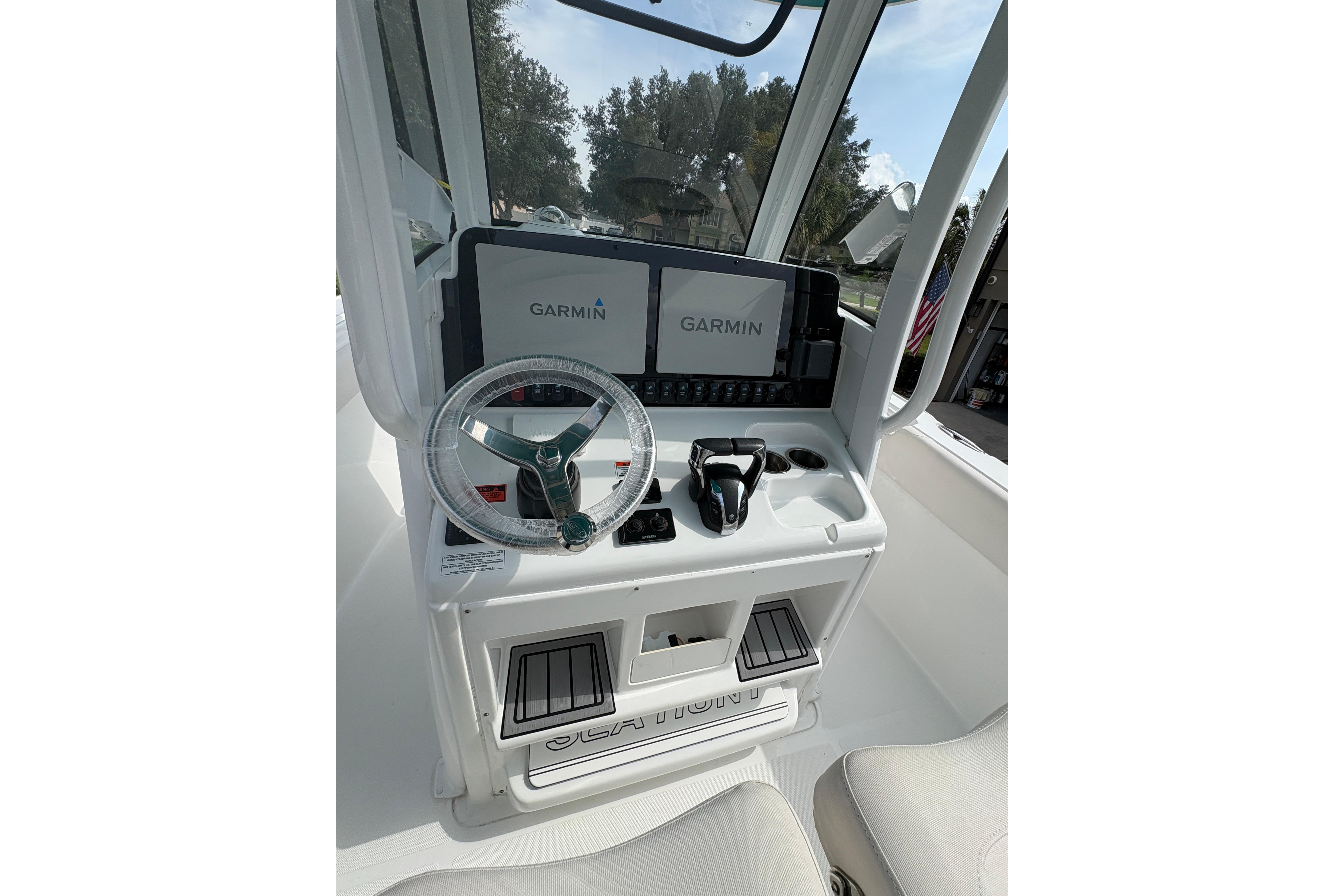Helm of 2021 Sea Hunt Ultra 265 SE with Garmin displays and steering wheel.