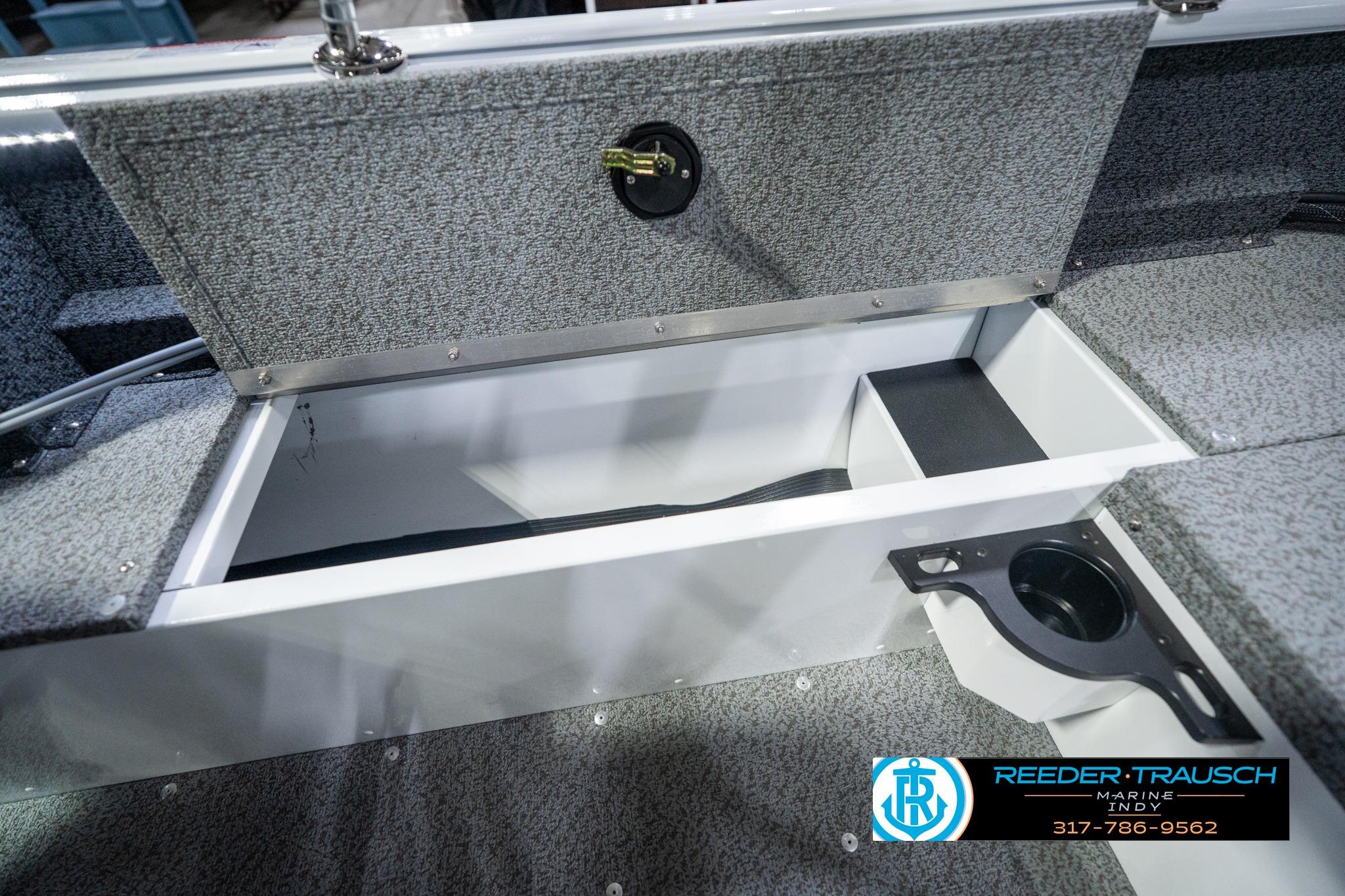 2026 Lund 1700 Explorer Sport boat storage compartment with cup holder, showcased by Reeder-Trausch Marine.