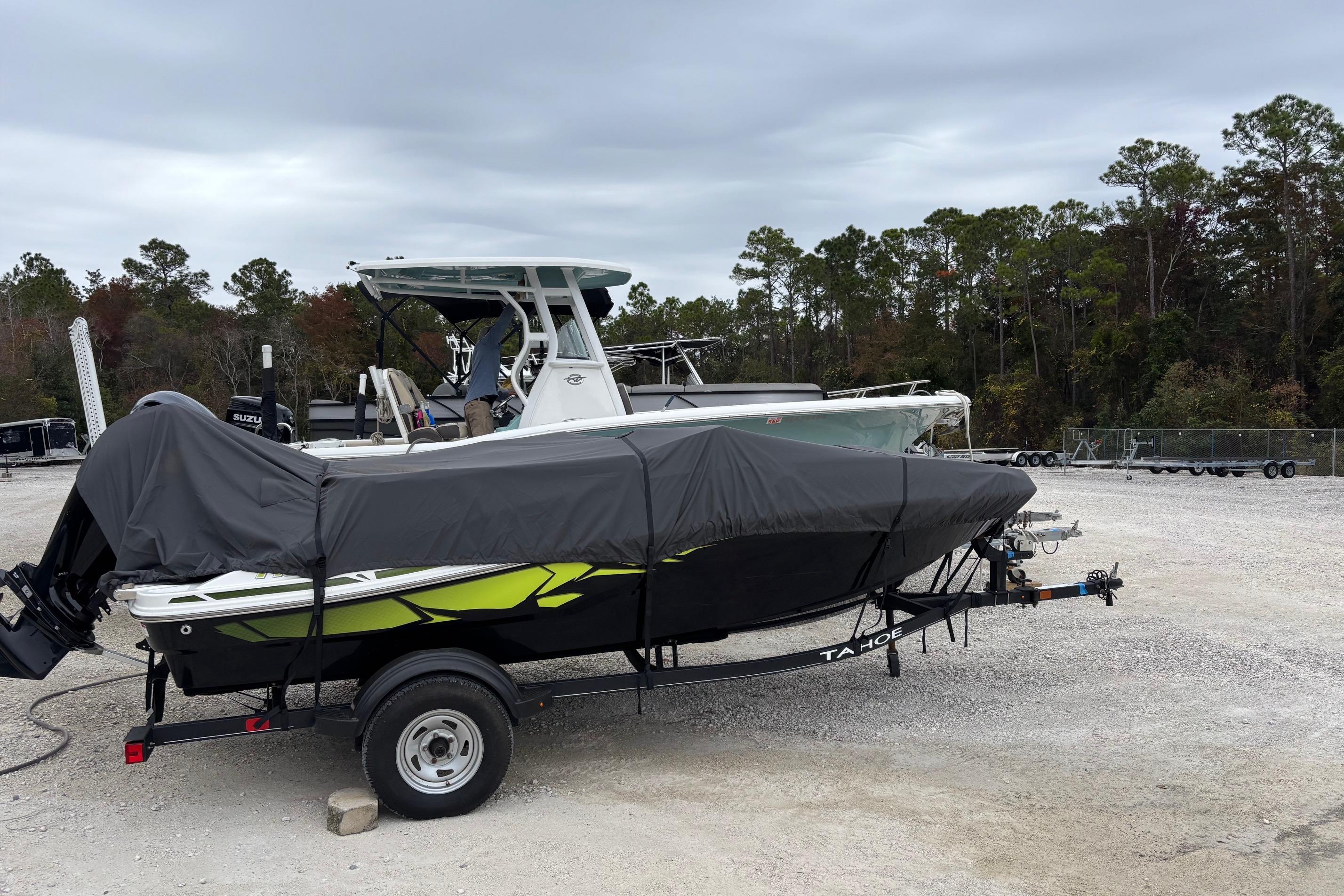 2022 Tahoe T16 boat covered on trailer in outdoor storage area.