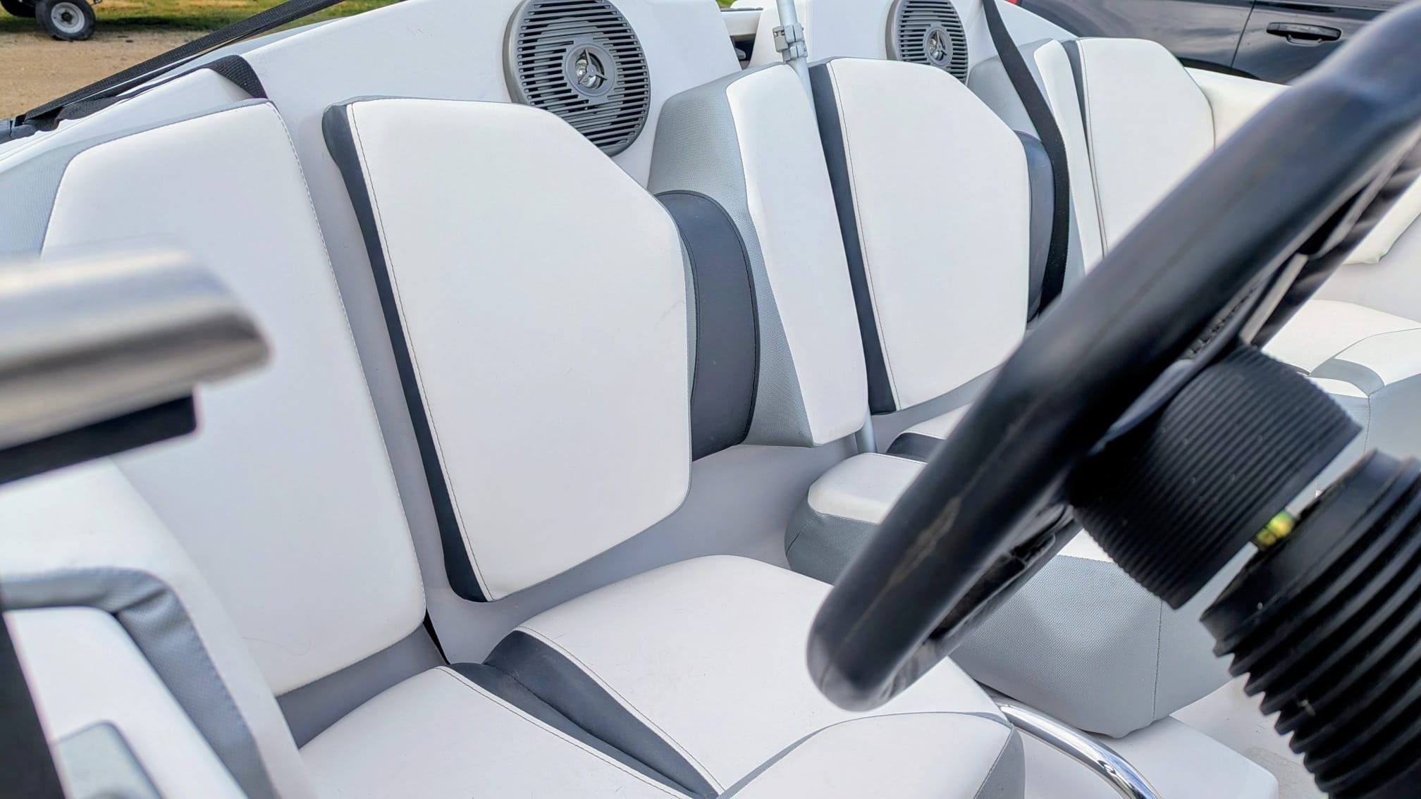 Interior of a 2017 Scarab 165 H.O. boat with white seats.