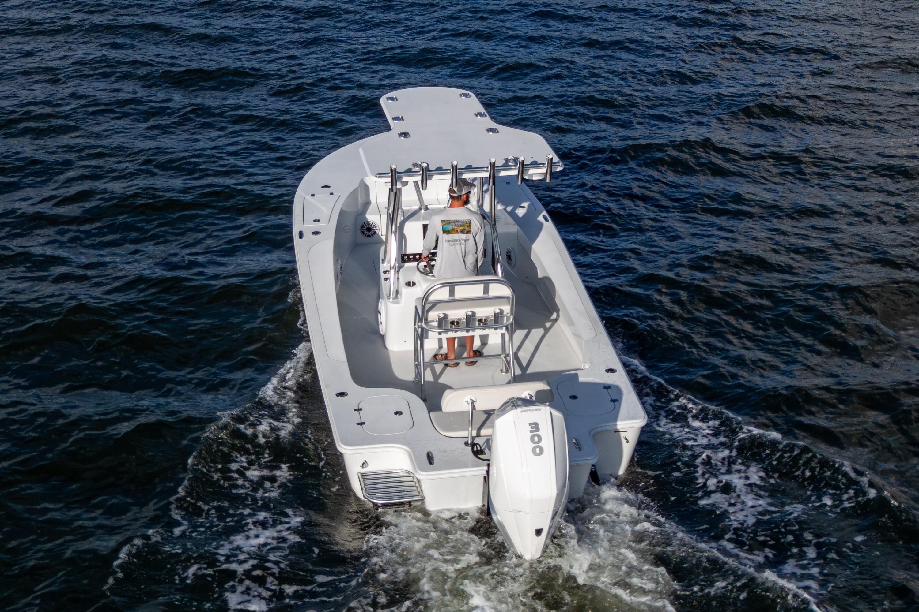 2022 Conch 25 boat cruising on open water, rear view.
