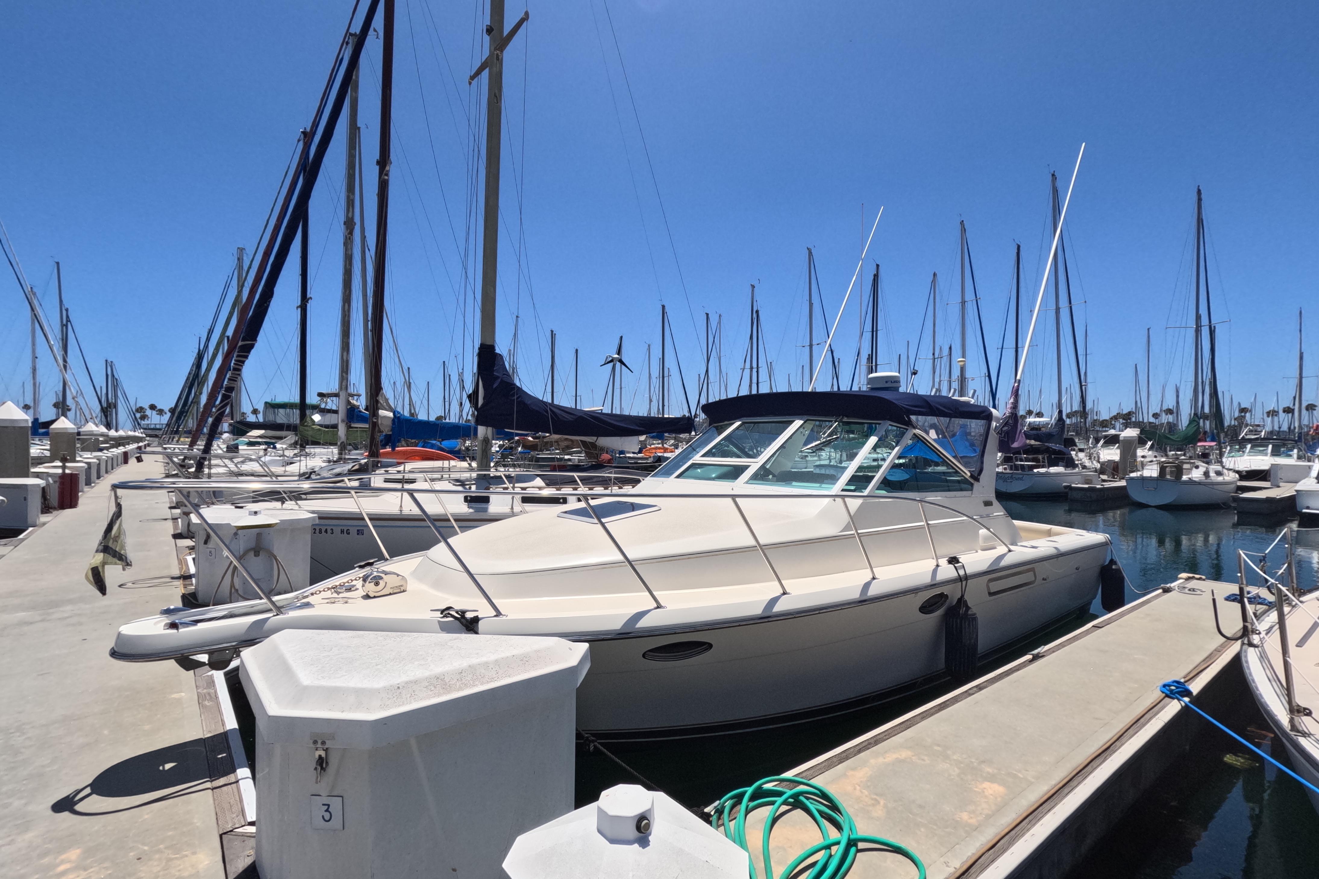 1995 Tiara Yachts 2900 Open docked at a marina under clear blue skies.