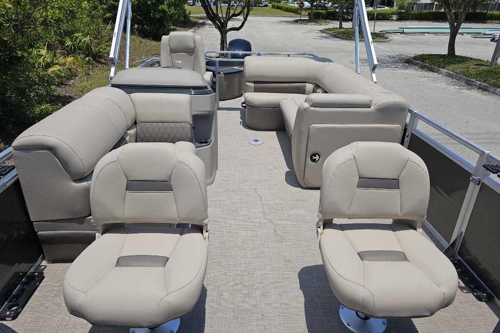 2025 Sun Tracker SportFish 20 DLX pontoon boat with beige seating and spacious layout.