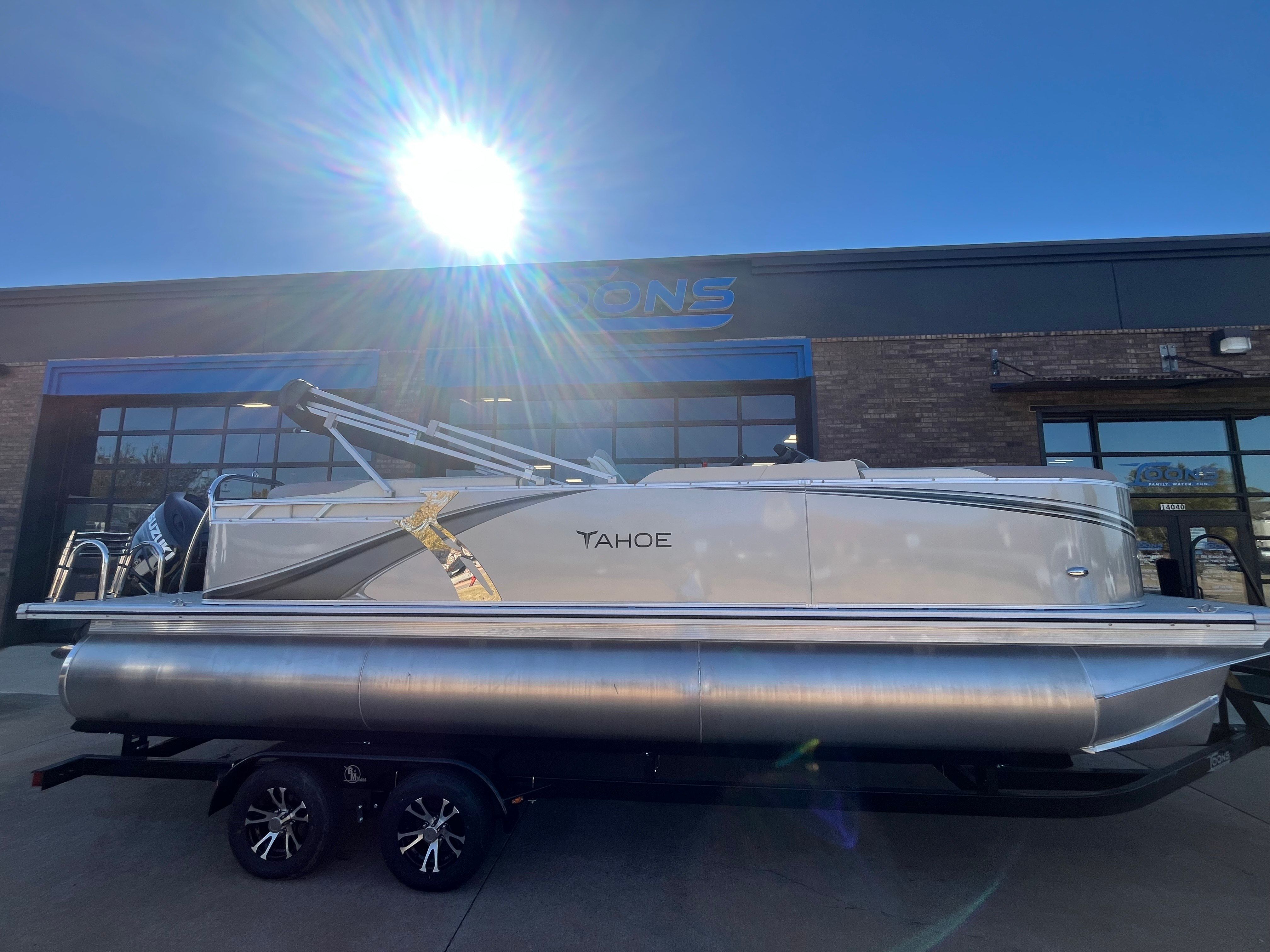 2026 Tahoe 2385 LTZ Quad Lounger pontoon boat in sunlight.