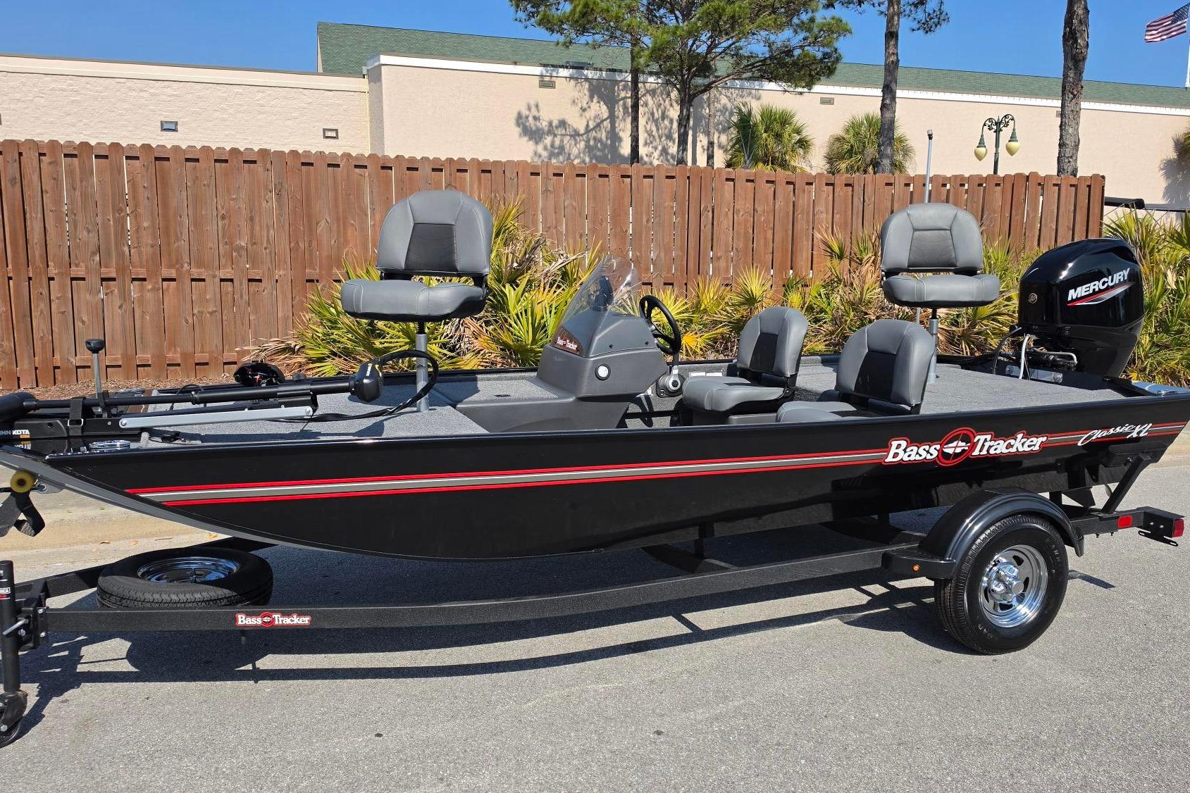 2026 Tracker Bass Tracker Classic XL fishing boat with Mercury engine, parked outdoors.