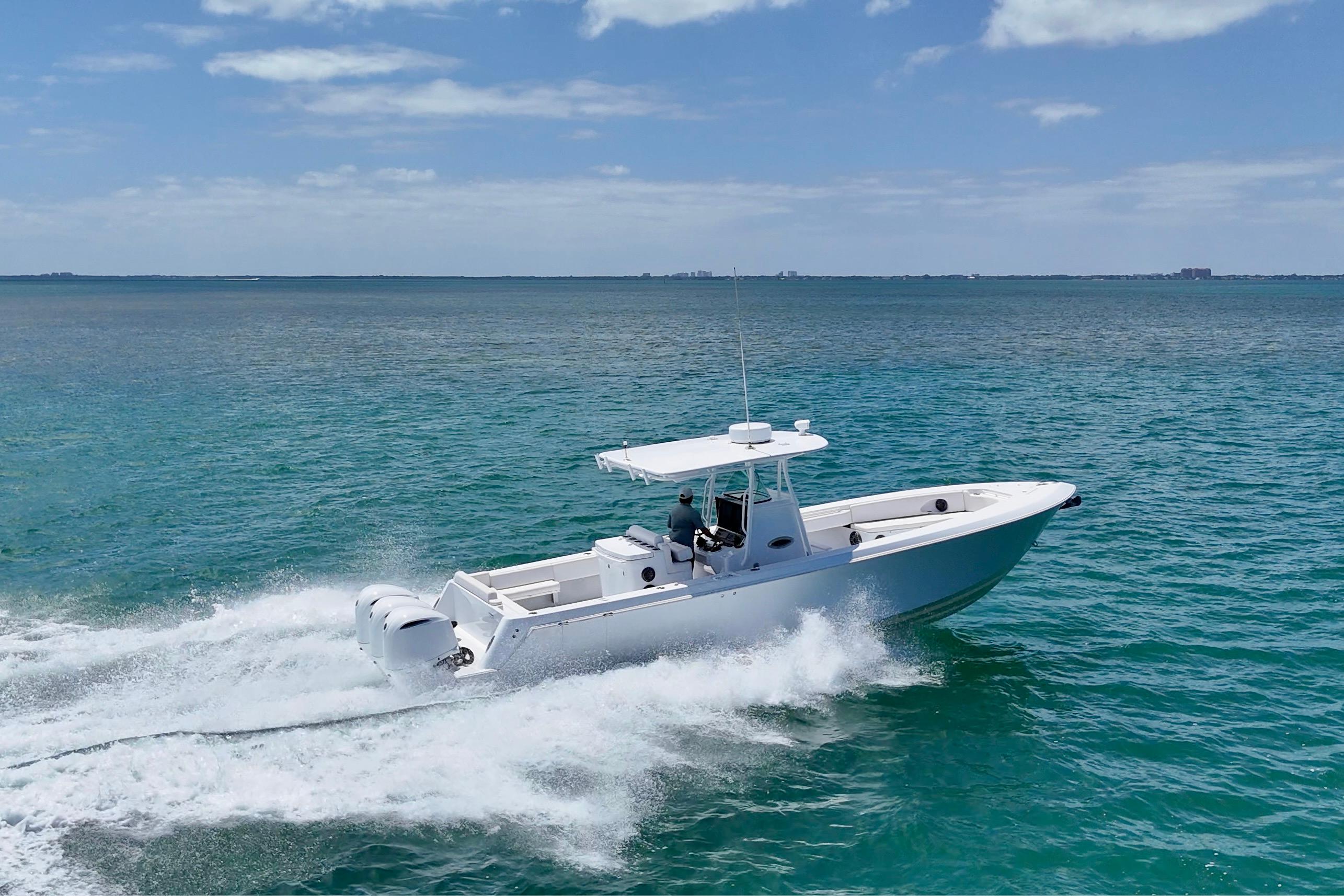 2013 Contender 35 LS boat cruising on clear blue ocean waters.