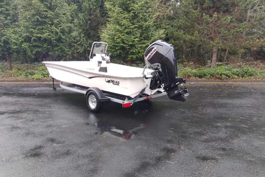 2026 Mako Pro Skiff 17 CC boat on trailer, parked outdoors.