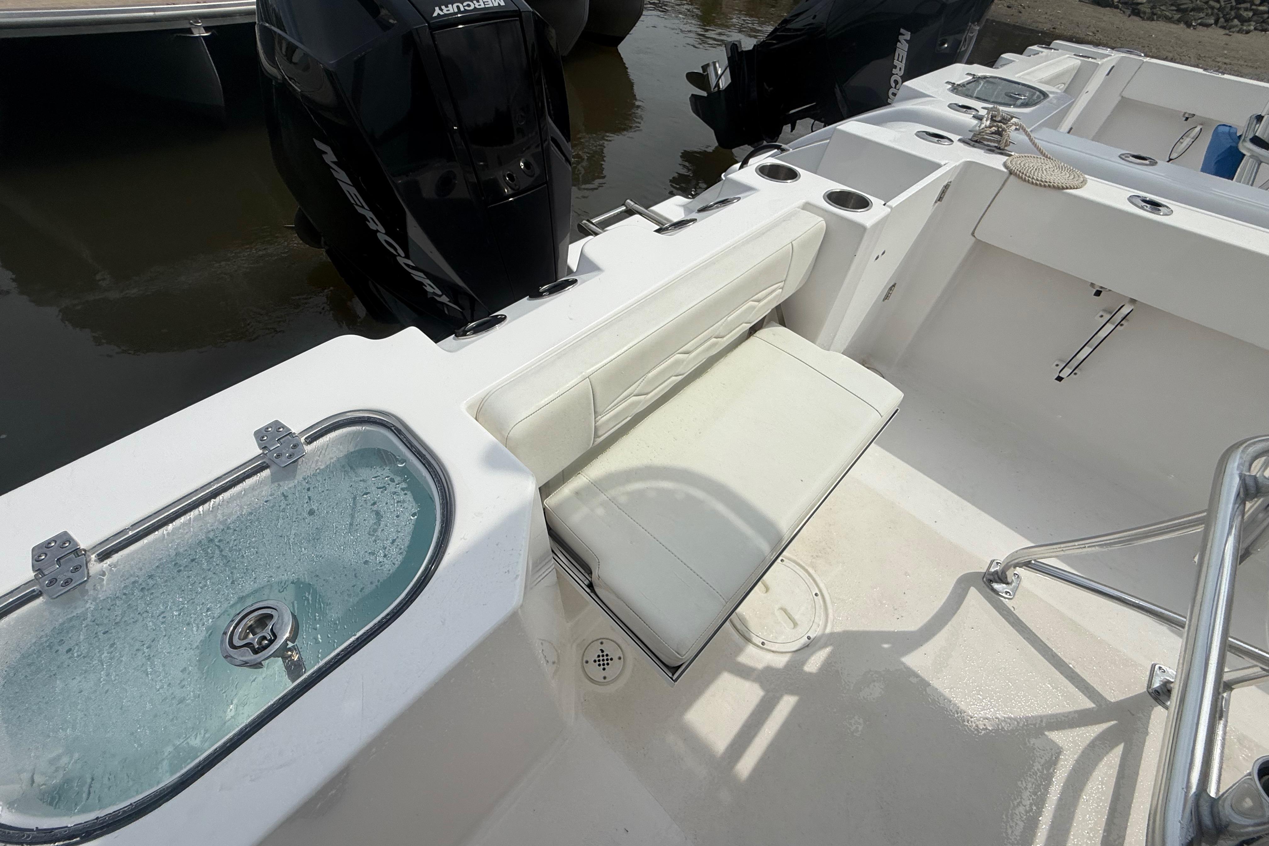 2024 Aquasport 2200 Center Console boat interior with seating and livewell.