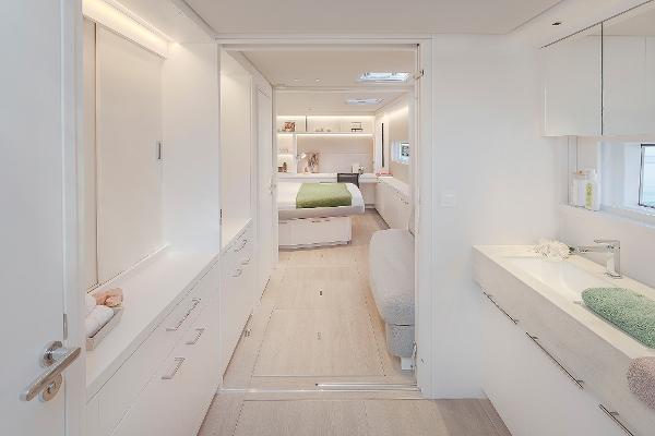 Luxurious interior of 2025 Lagoon SIXTY 5 yacht, featuring modern bedroom and bathroom design.
