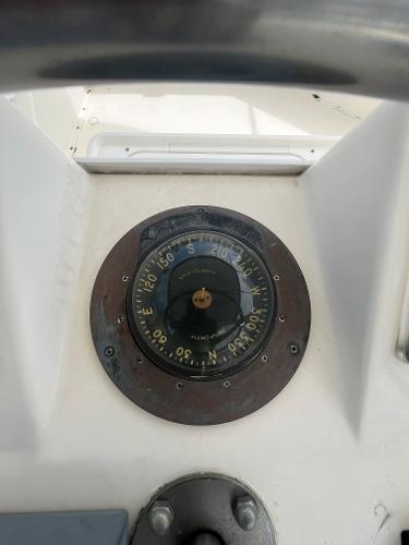 Compass on 1985 Hatteras 45 Convertible boat dashboard.
