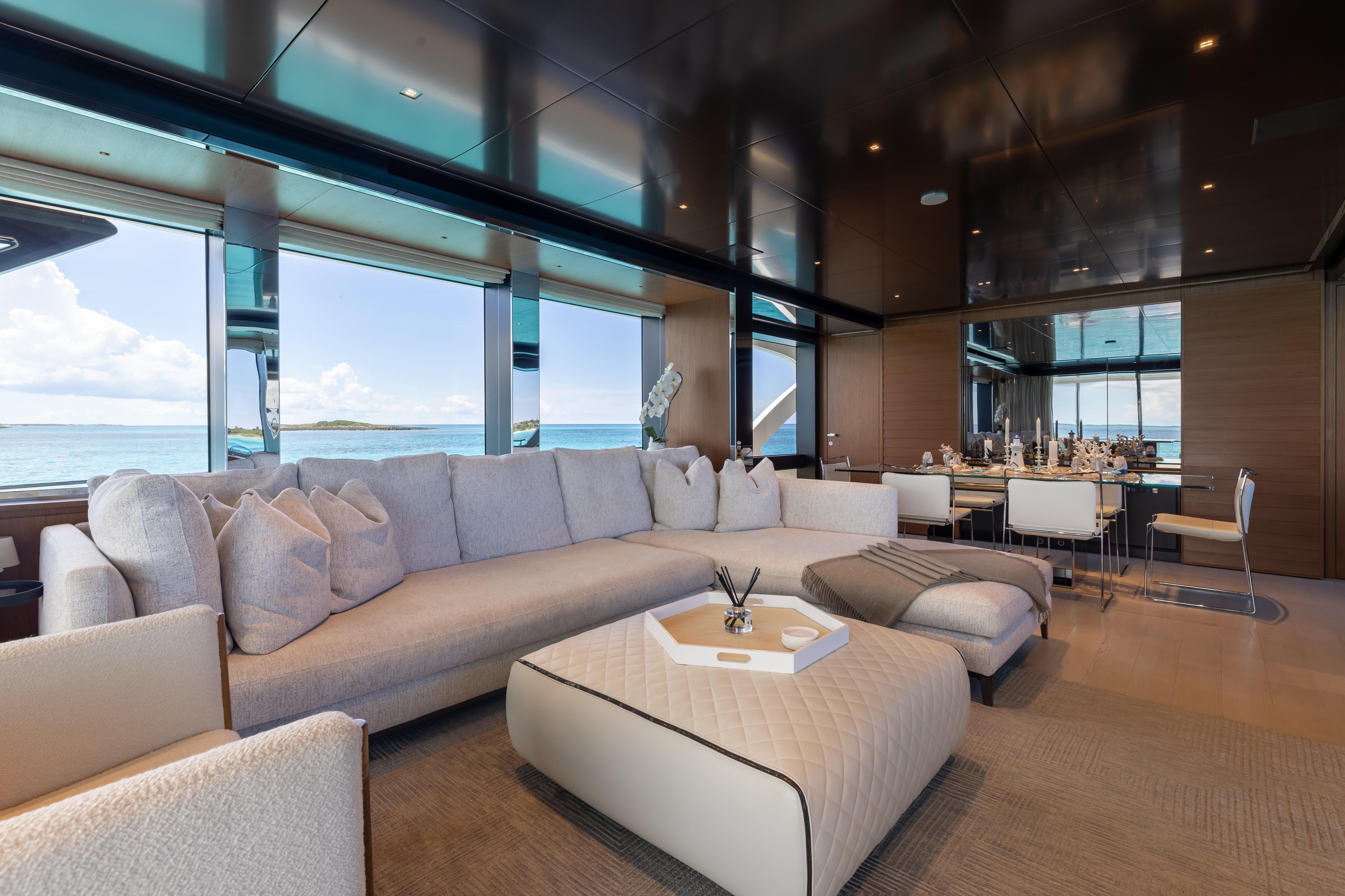 Luxurious interior of 2020 Riva 90 Argo yacht with elegant seating and ocean view.