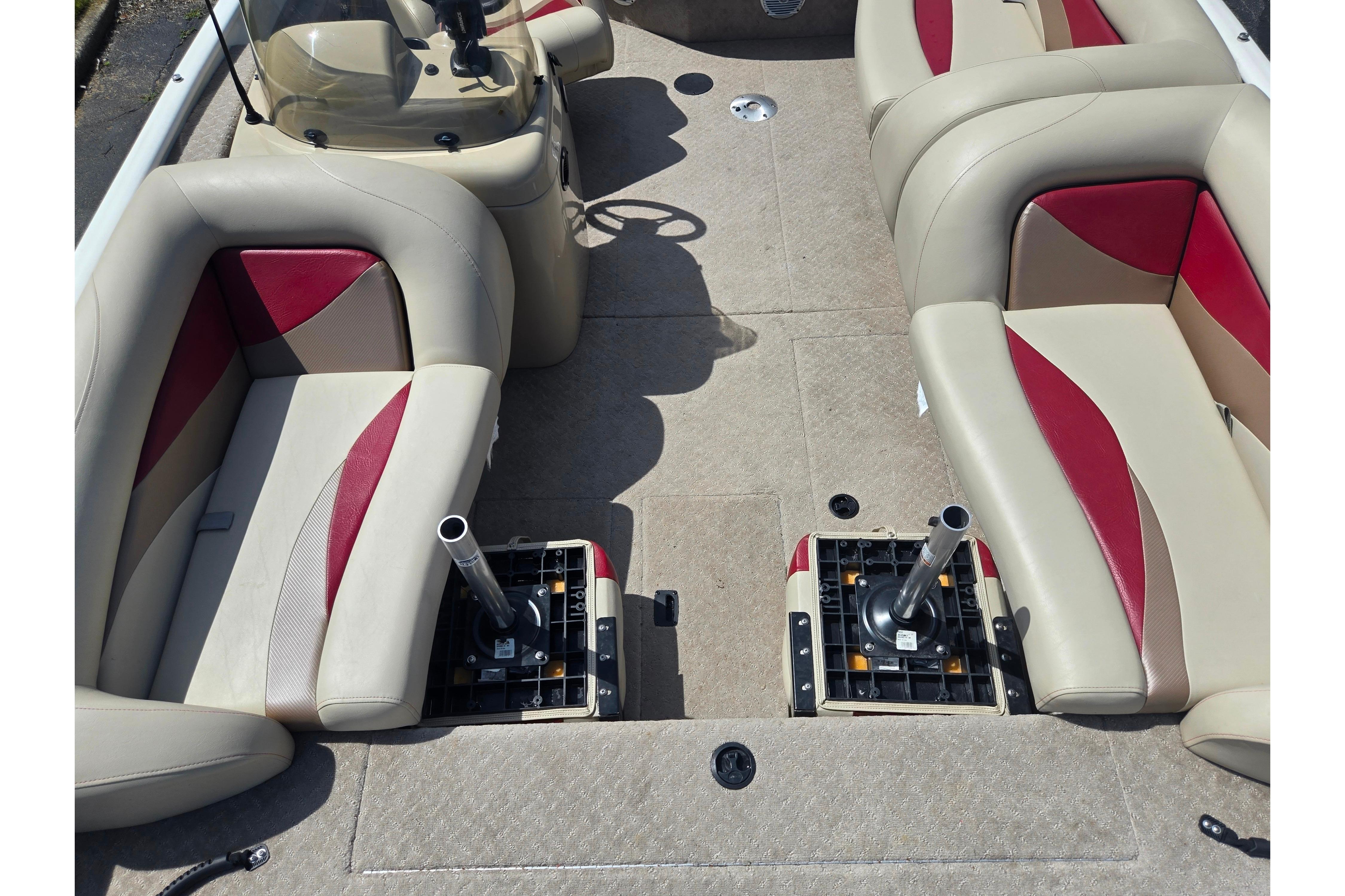 2015 Lowe Sport Deck 224 interior with beige and red seating, steering console, and open floor space.