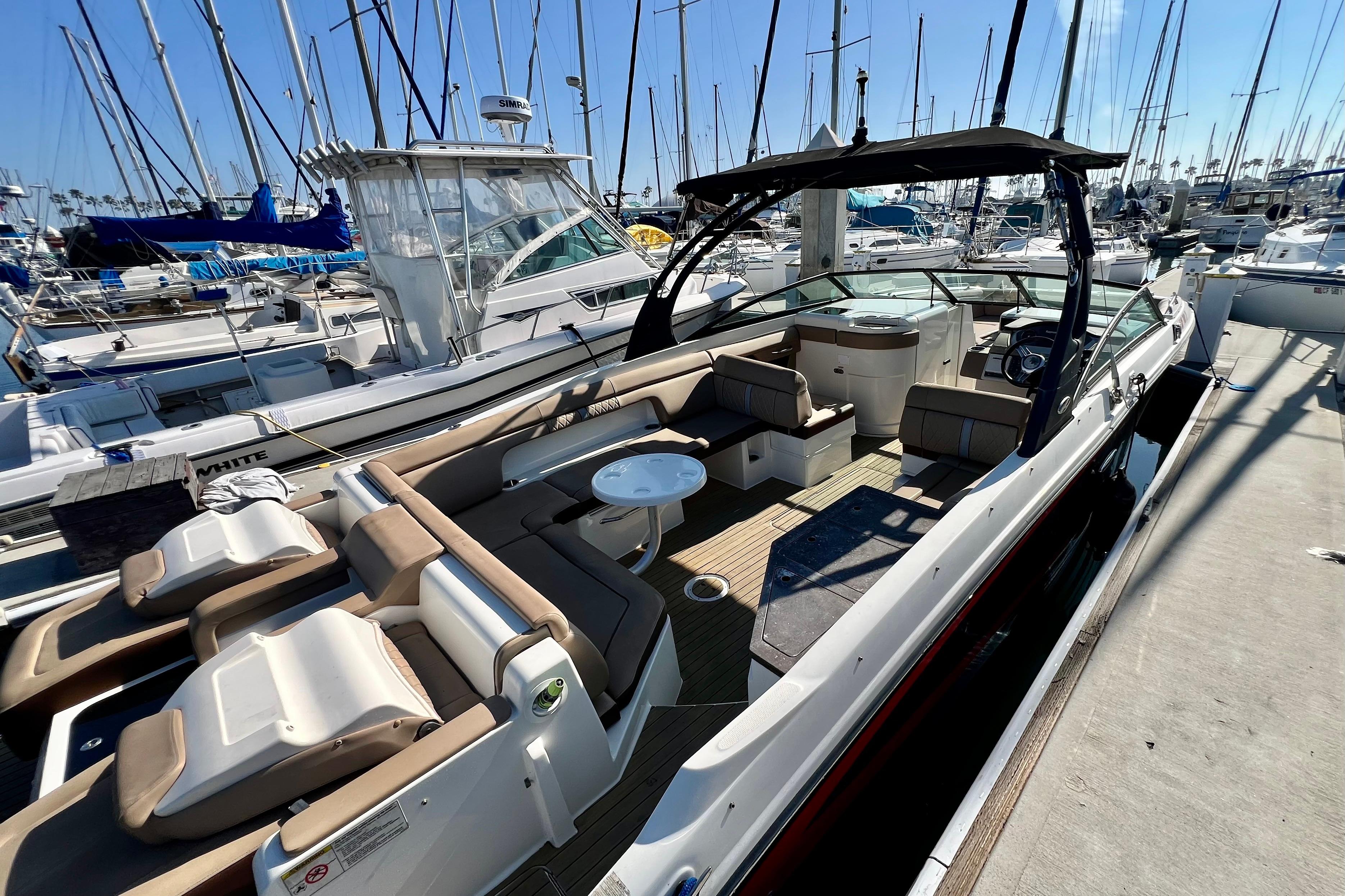 2016 Sea Ray 290 Sundeck Outboard docked, featuring spacious seating and sleek design.