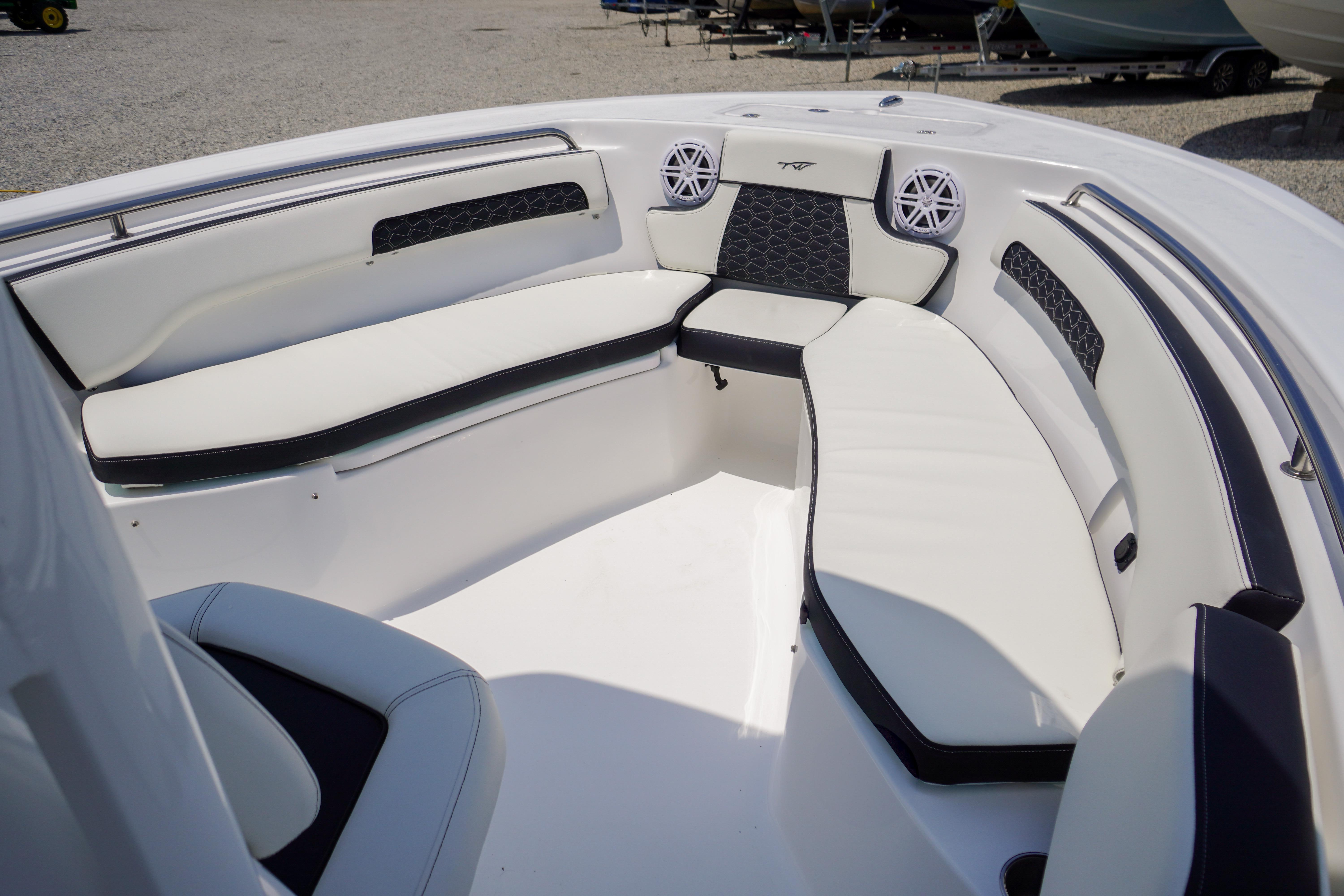 2027 Tidewater 220 CC Adventure boat interior with cushioned seating and speakers.