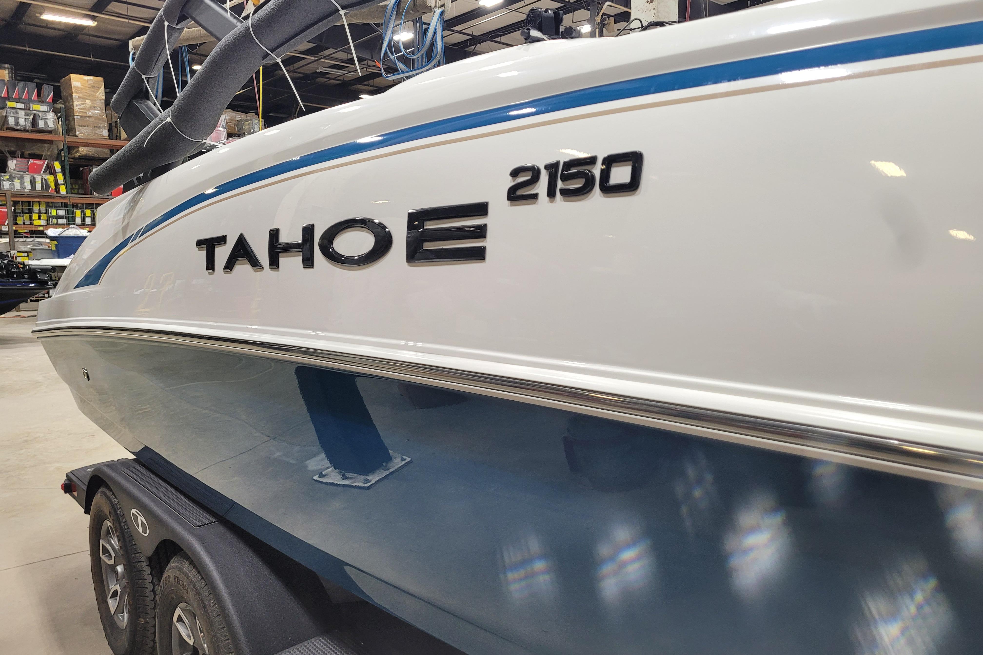 2026 Tahoe 2150 boat in showroom, featuring sleek design and modern detailing.