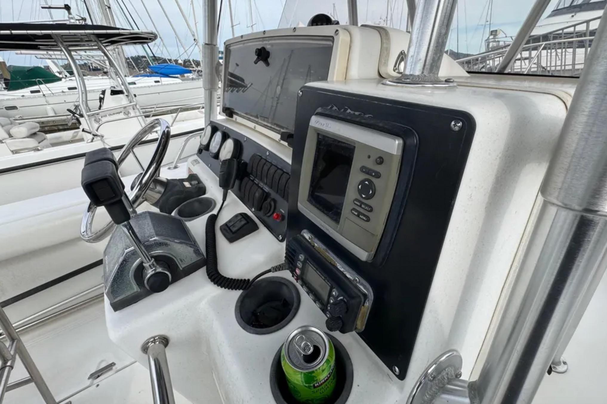 Control panel of a 2001 Boston Whaler 26 Outrage boat with navigation equipment.