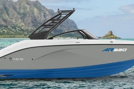 2026 Yamaha Boats AR220 on scenic water with mountains in the background.