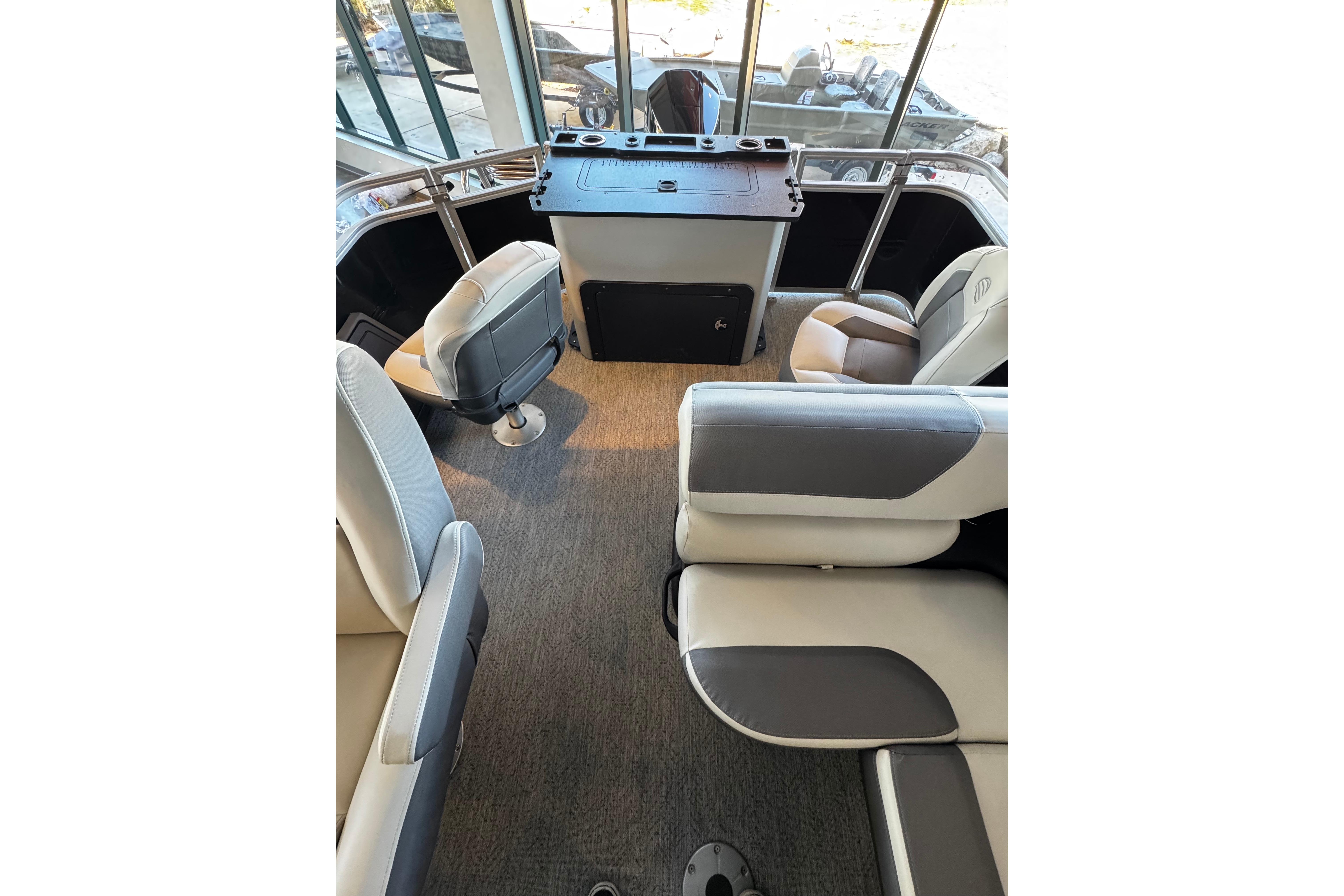 Interior of 2026 Sun Tracker Fishin' Barge 22 XP3 with modern seating and helm.