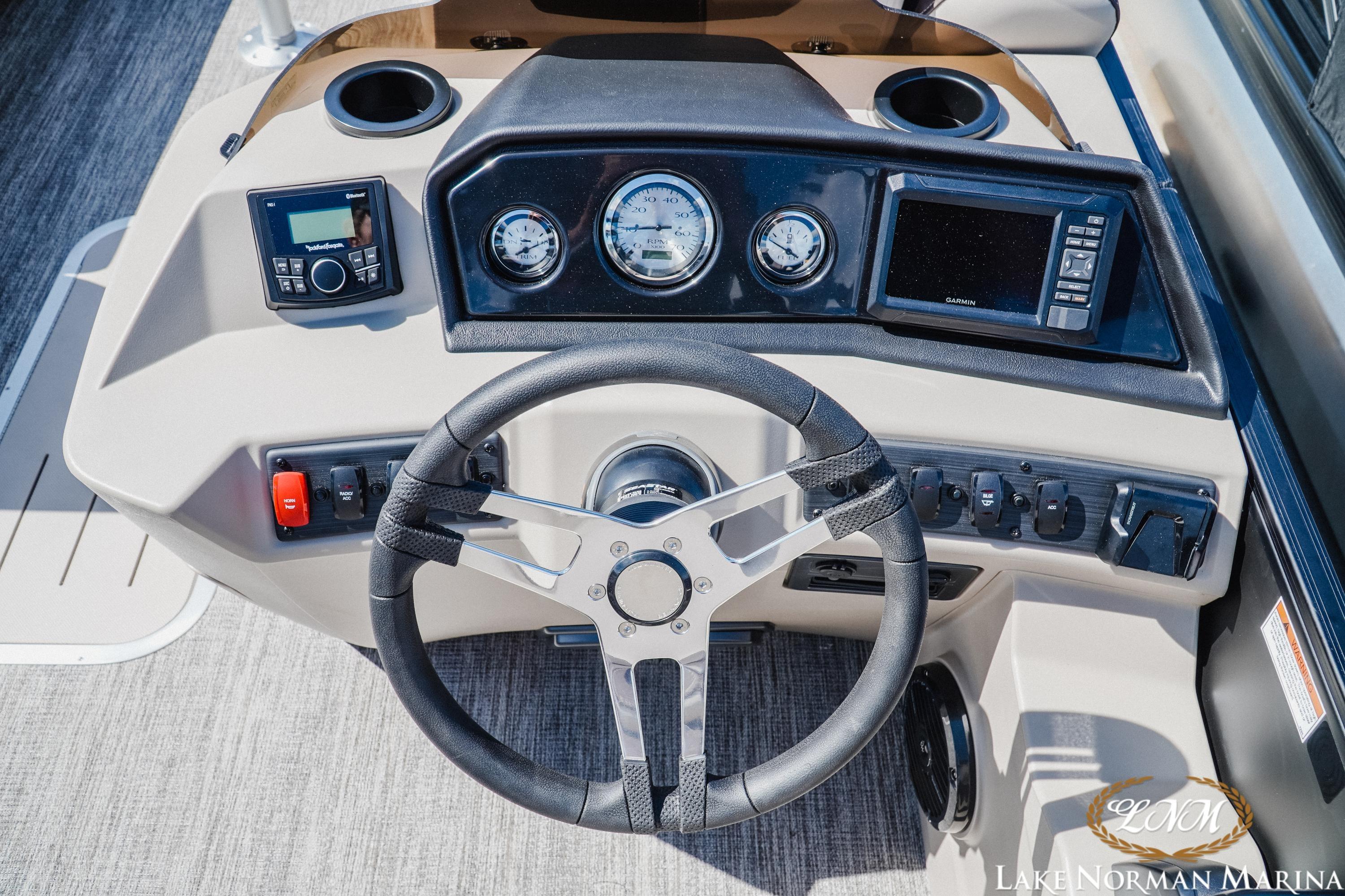 Steering console of a 2027 Bennington 23ssb boat with modern controls and gauges.