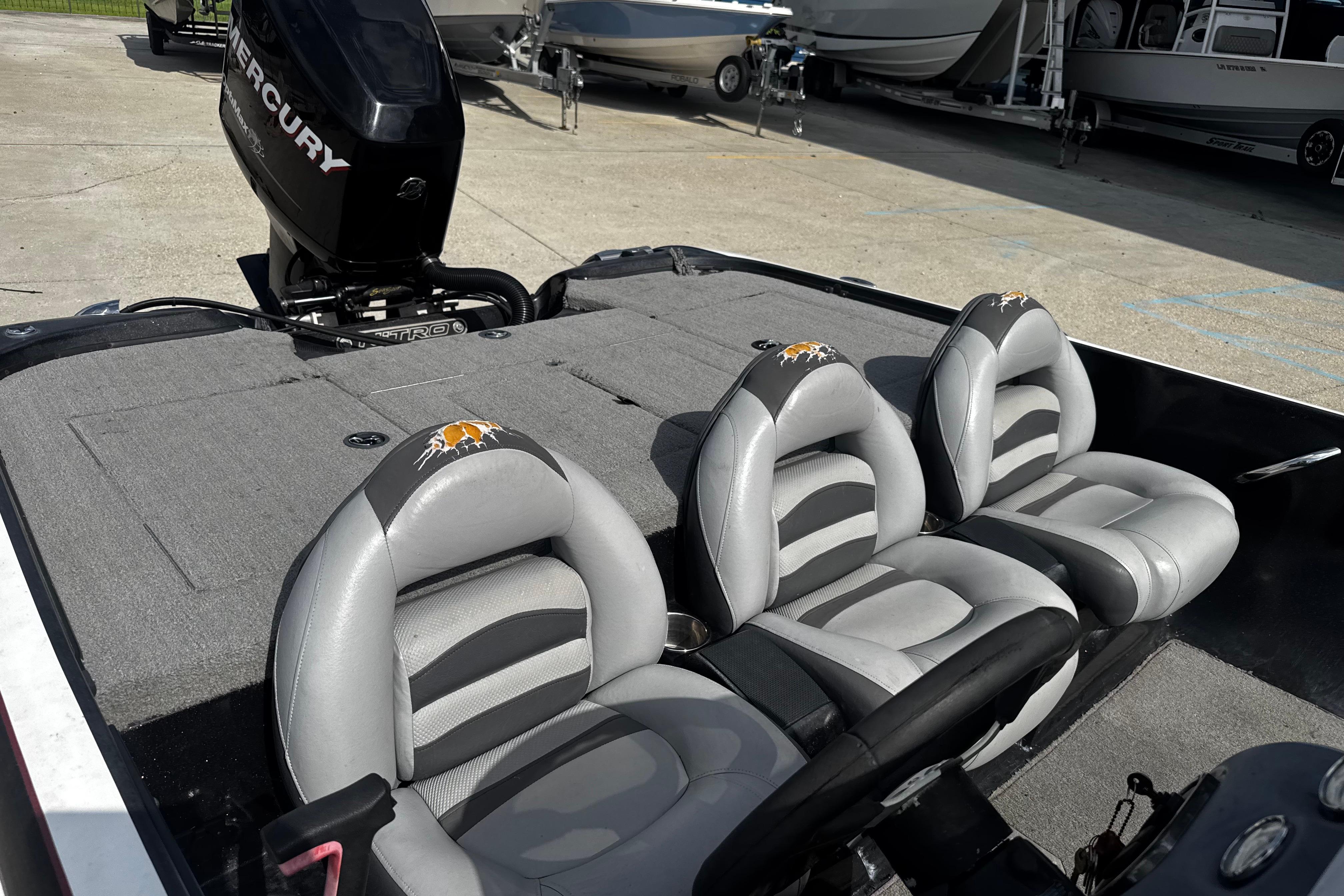 2012 Nitro Z-7 boat interior with three gray seats and a Mercury engine.
