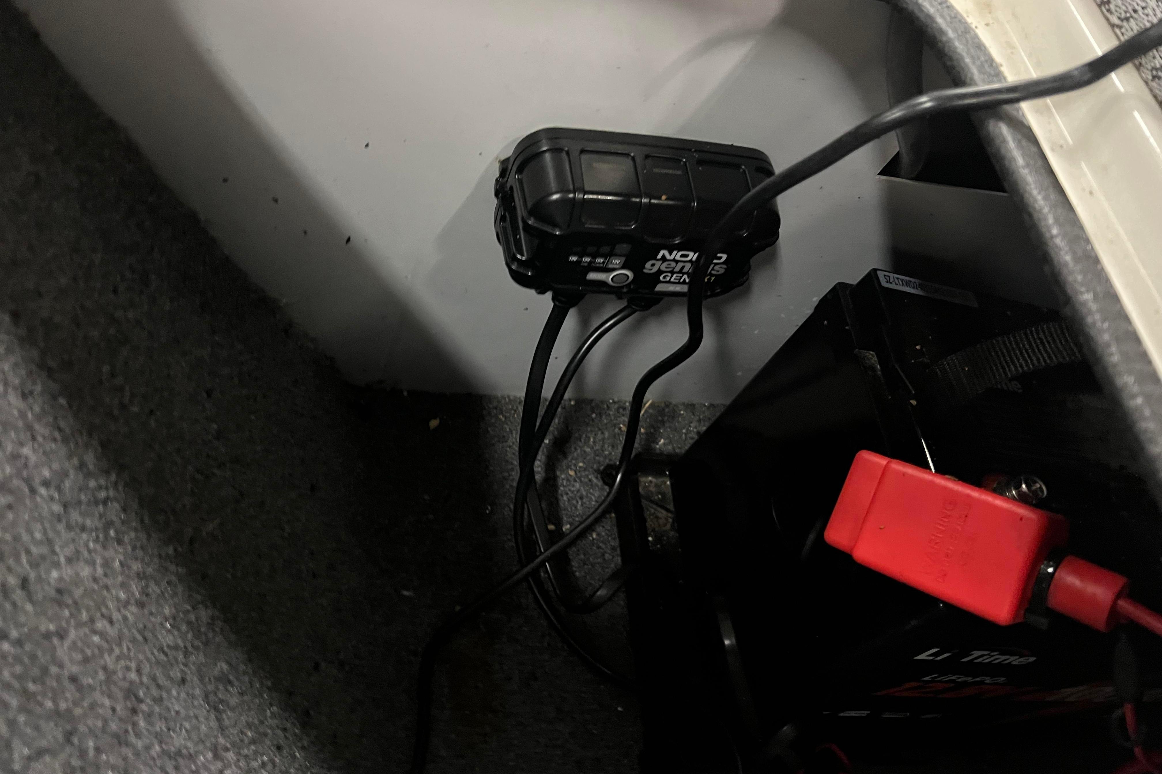 2022 Tracker Pro Guide V-16 WT battery compartment with charger and wiring.