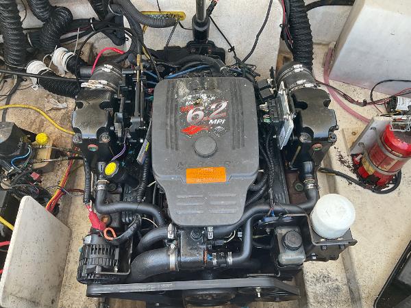 2006 Chaparral 256 SSi engine compartment with 6.2 MPI engine and fire extinguisher.