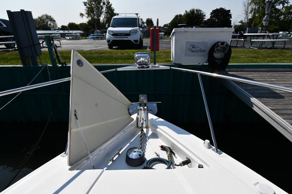 2010 Cruisers Yachts 390 Sports Coupe docked, showing bow details and marina surroundings.