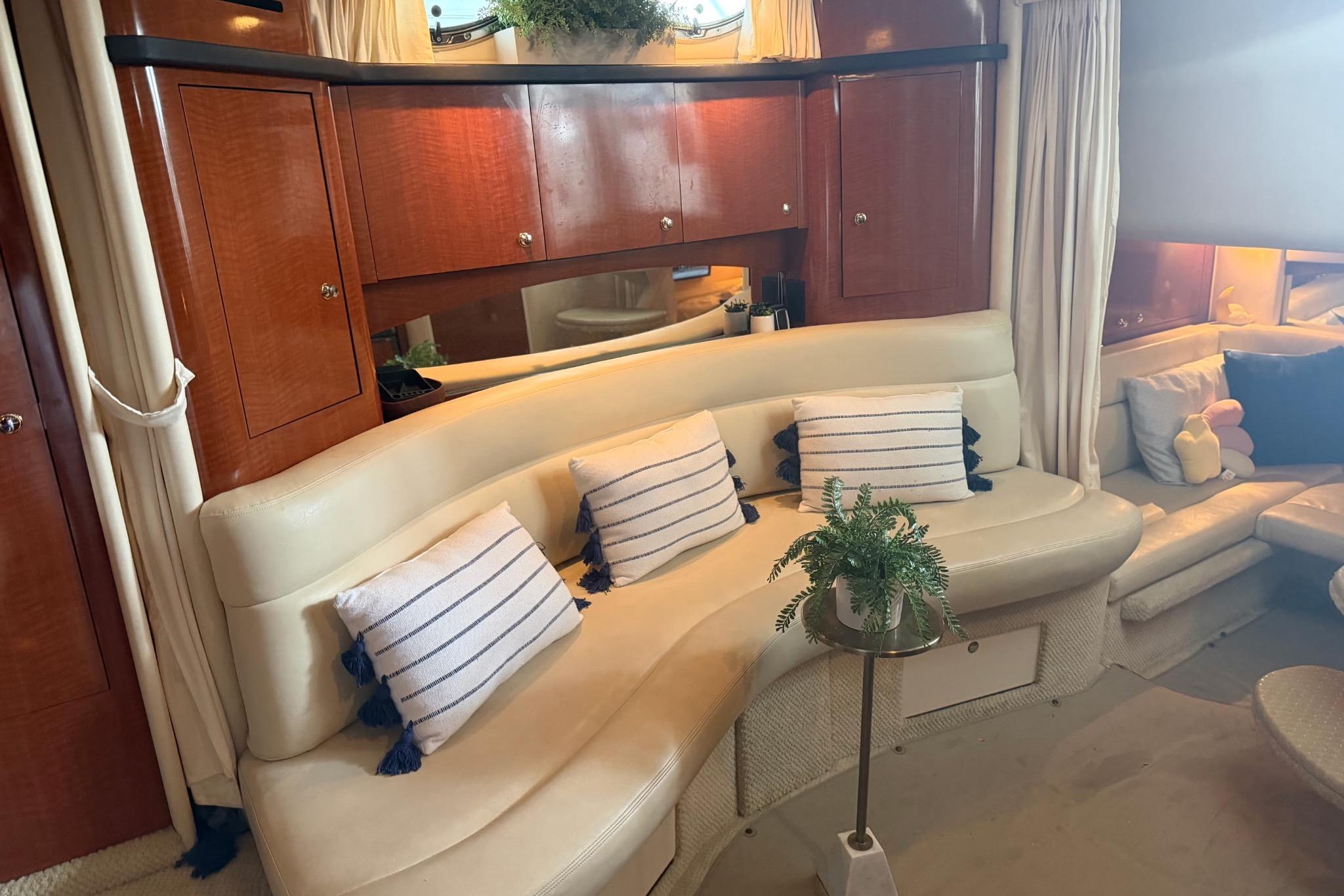 Luxurious interior of 2002 Sea Ray Sundancer 320 yacht with plush seating and elegant decor.
