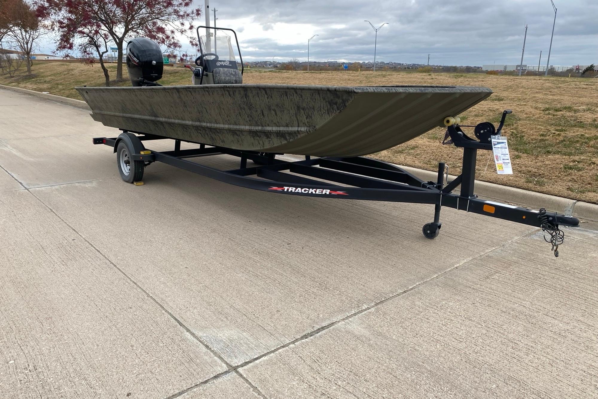 2026 Tracker Grizzly 2072 CC boat on trailer, parked on a paved road.