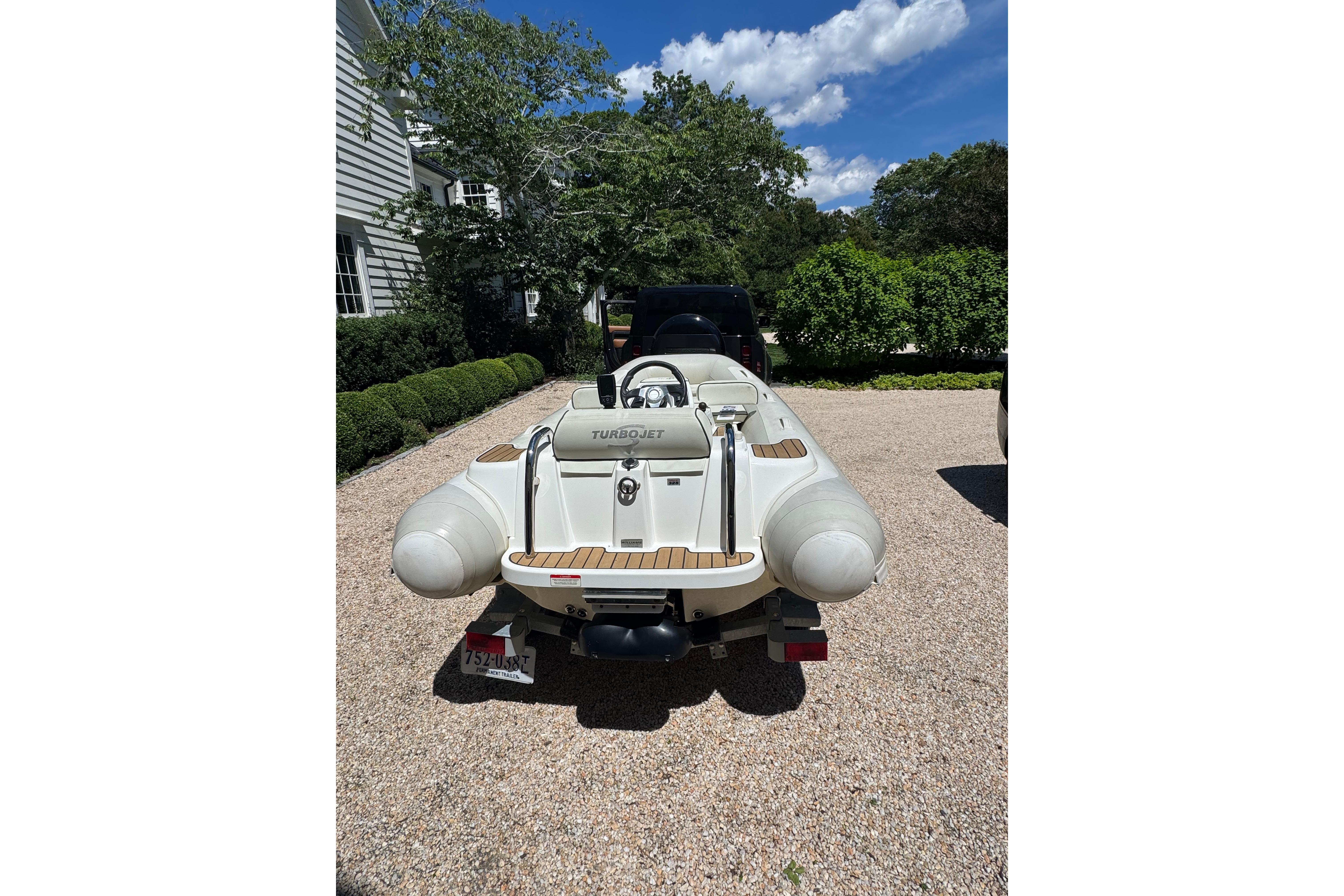 2017 Williams Jet Tenders Turbojet 325 on trailer, parked in a sunny driveway.