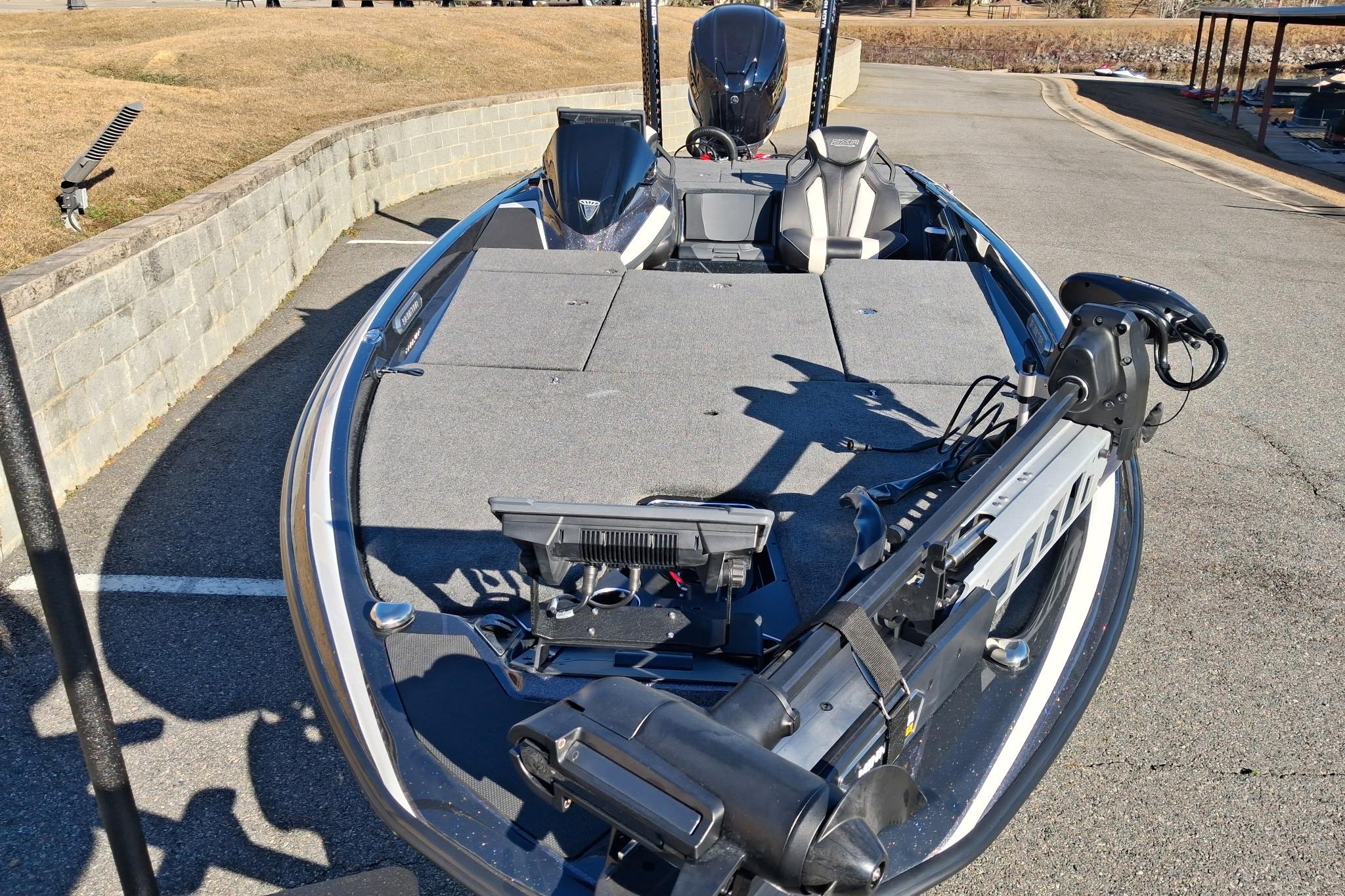 2026 Skeeter FXR21 FLEX fishing boat with advanced equipment, parked on pavement.