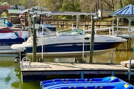 2008 Sea Ray 240 Sundeck boat docked at a marina with surrounding watercraft.