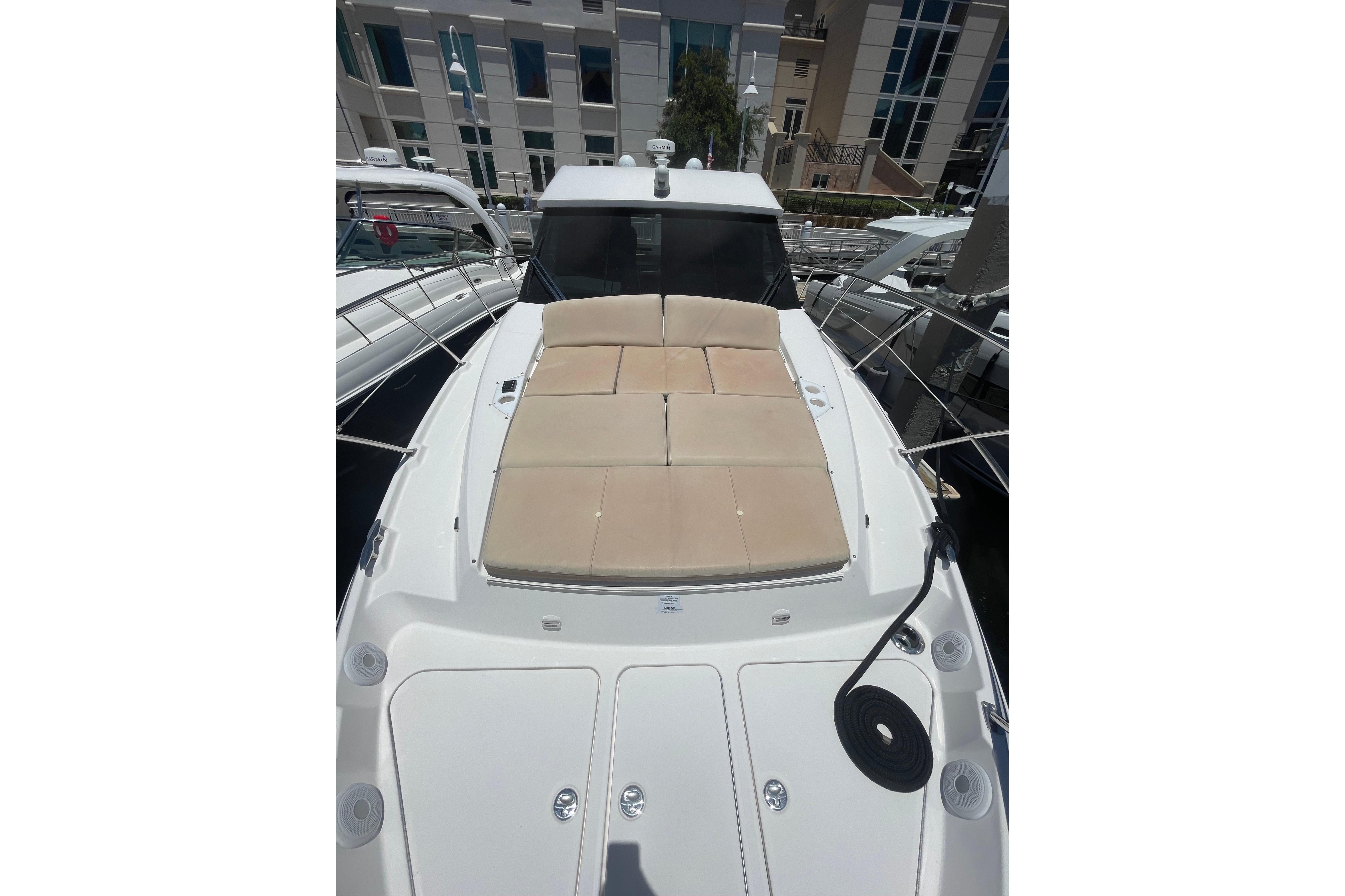 2020 Regal 42 Grande Coupe yacht with sunpad, docked at marina.