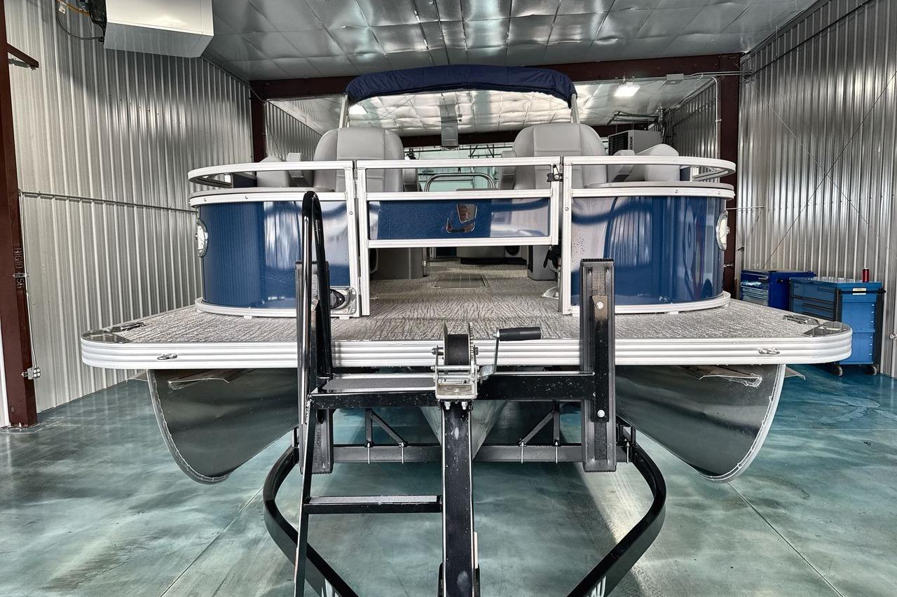 2026 Landau Island Breeze 23F pontoon boat in a metal storage facility.