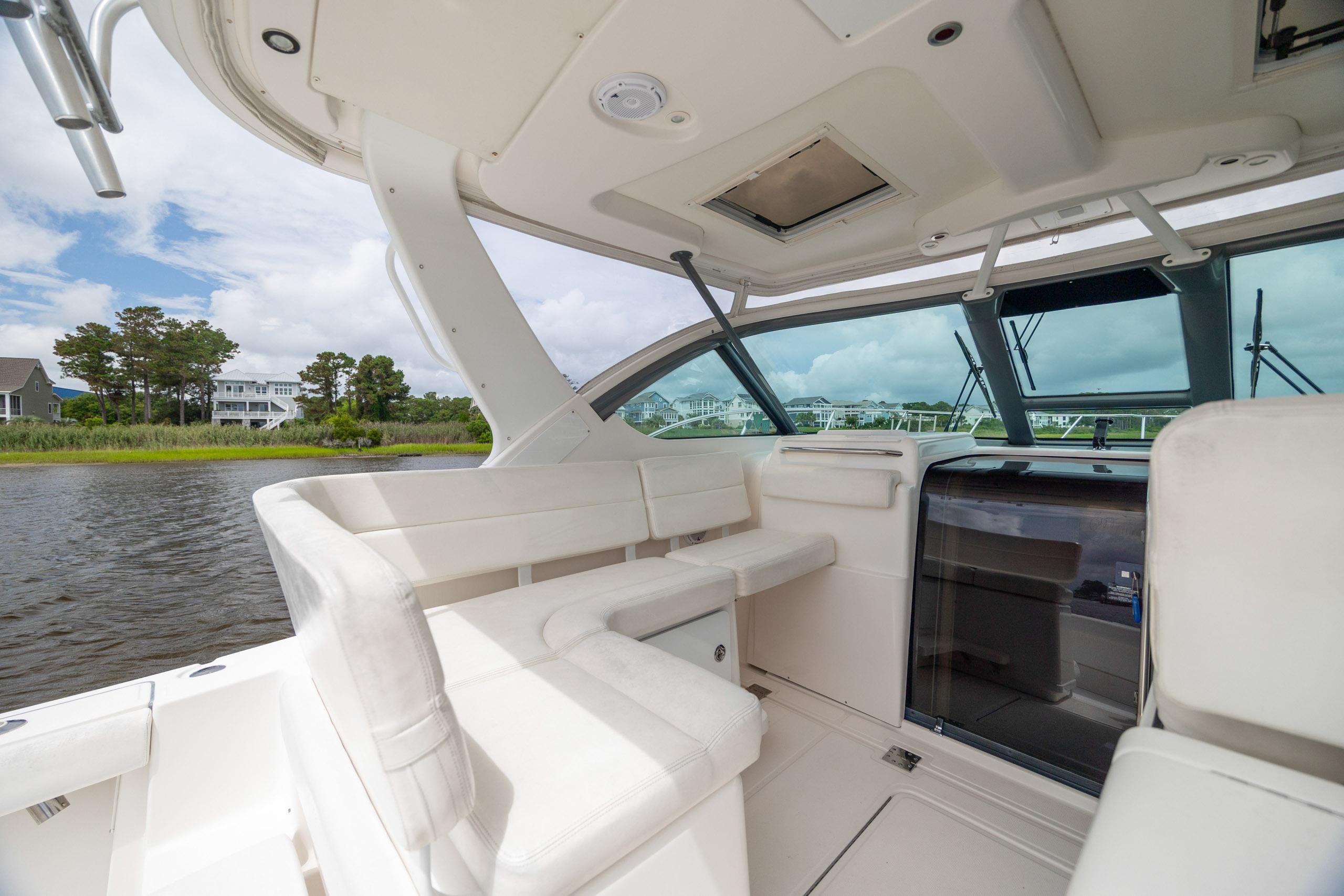 2004 Tiara Yachts 3200 Open interior with white seating and scenic water view.
