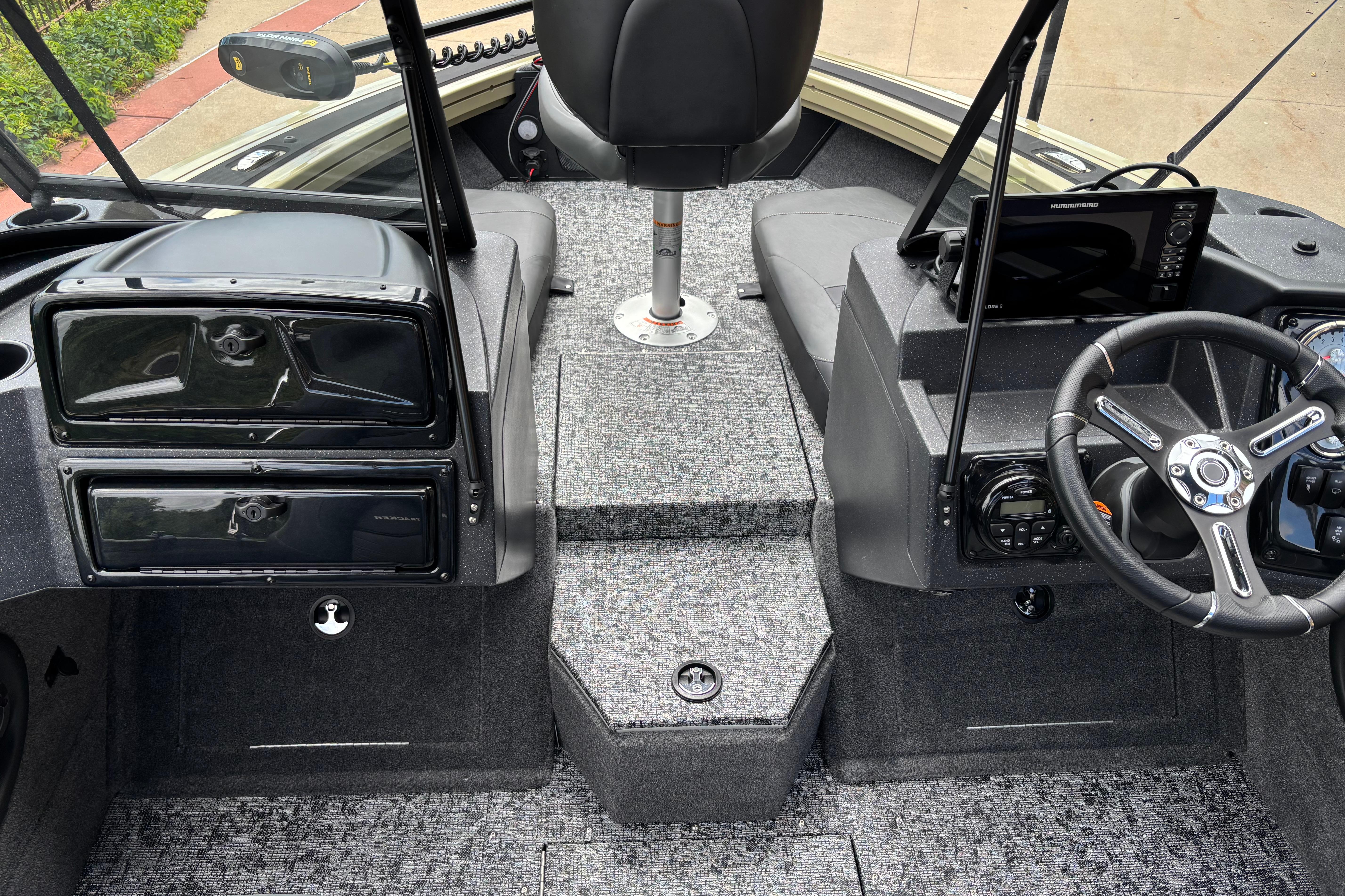 Interior view of 2026 Tracker Targa V-18 Combo boat cockpit with steering wheel and controls.