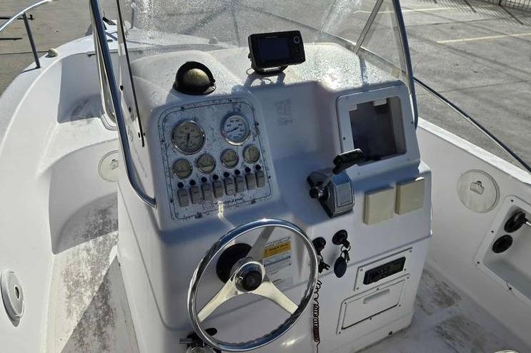 2001 Pro-Line 19 Sport boat dashboard with steering wheel and navigation instruments.