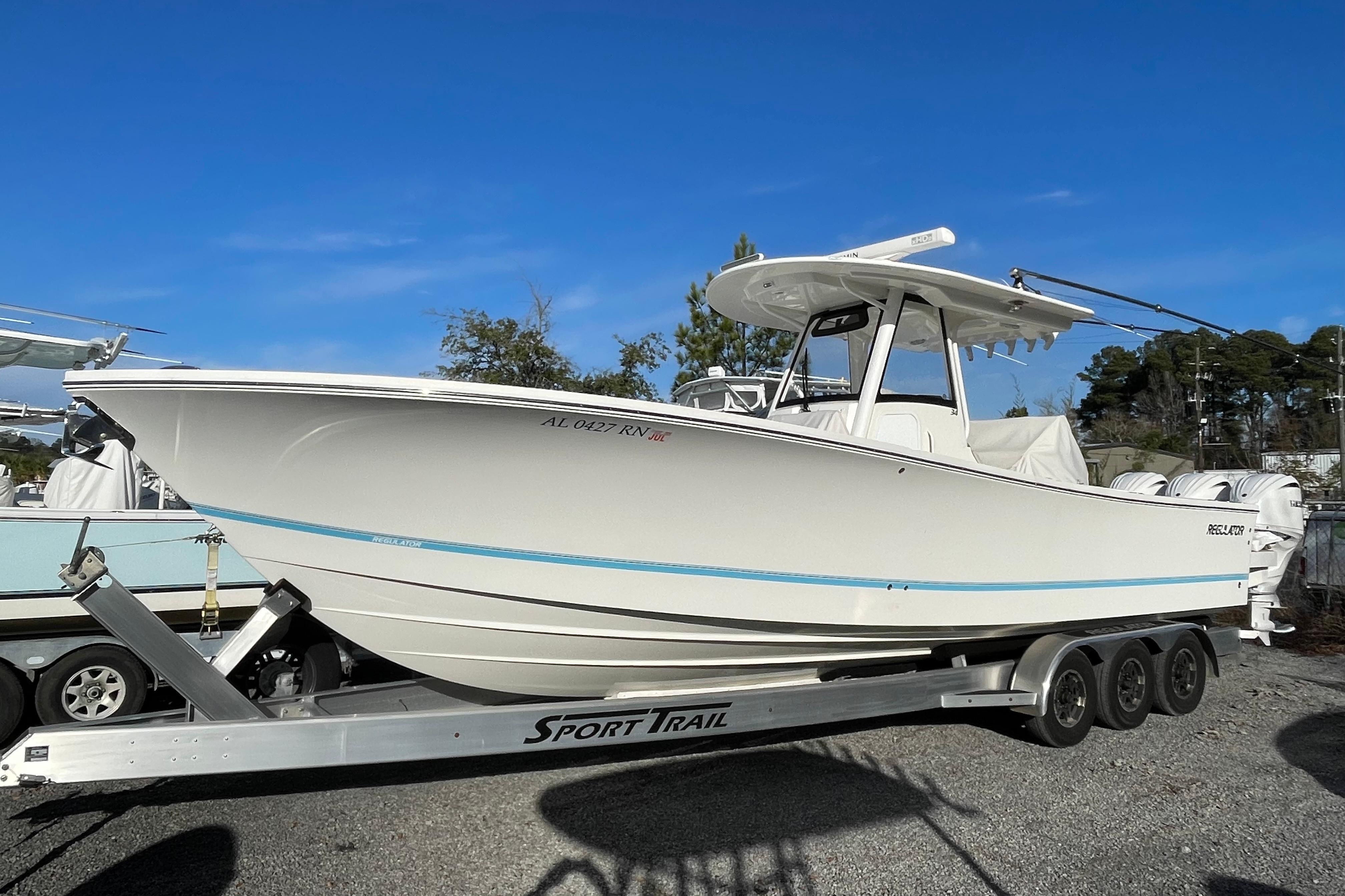 2023 Regulator 34 boat on trailer, side view, clear sky background.