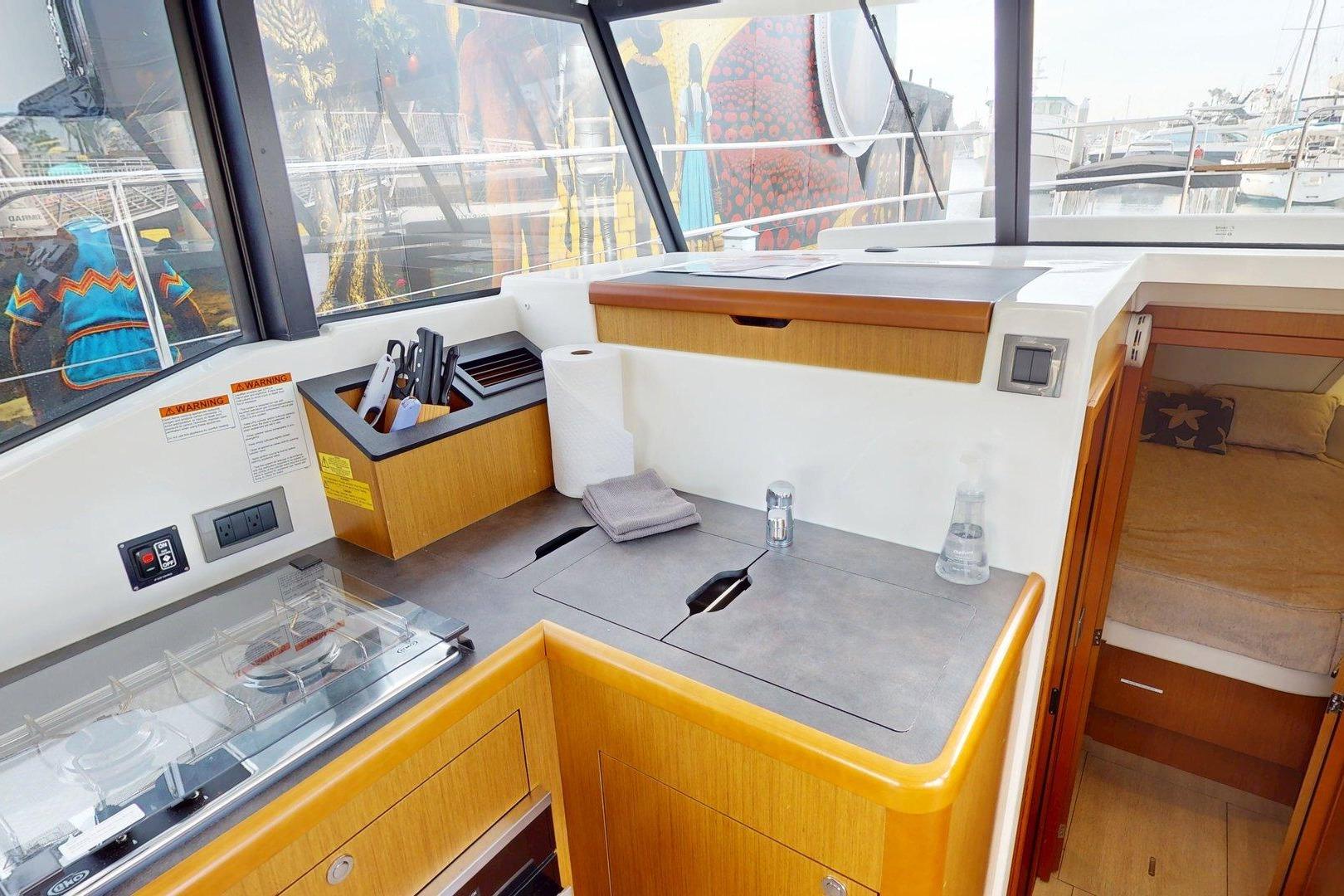 Interior of 2021 Beneteau Swift Trawler 35, featuring modern kitchen and cozy cabin.