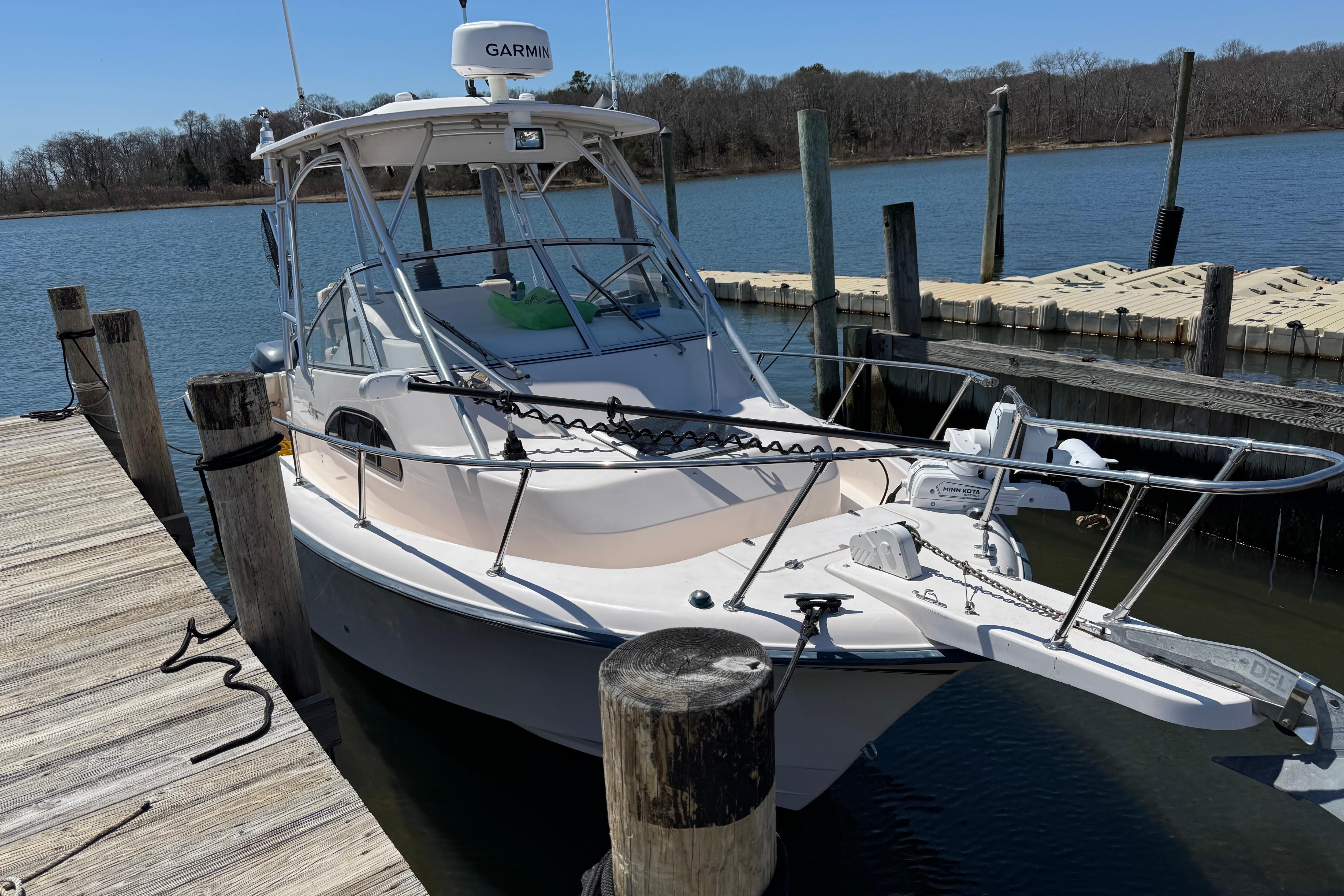 2004 Grady-White Sailfish 282 boat docked at a marina, featuring Garmin equipment.