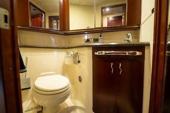 Luxurious bathroom in 2006 Sea Ray 580 Sedan Bridge yacht with elegant wood cabinetry.