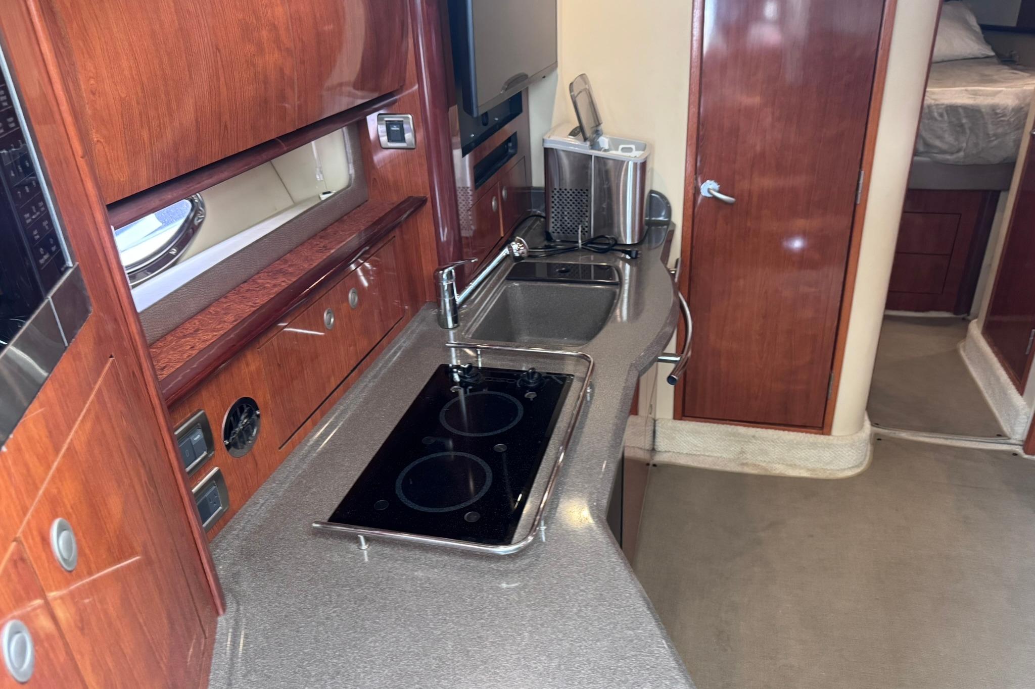 Luxurious 2004 Sea Ray 390 Sundancer yacht interior with modern kitchen amenities.