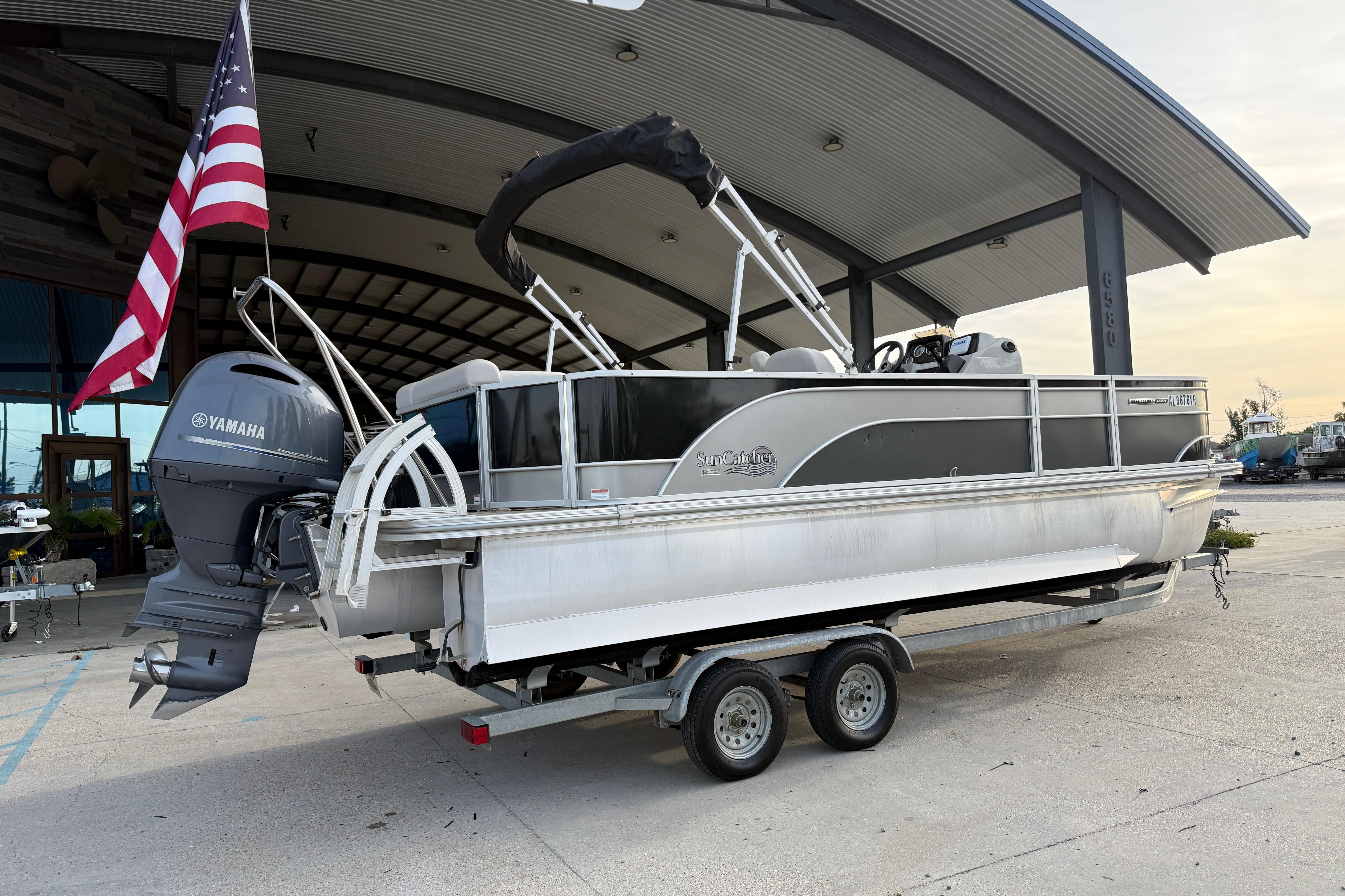 2022 Custom G3 Suncatcher 322FC pontoon boat with Yamaha motor and American flag.