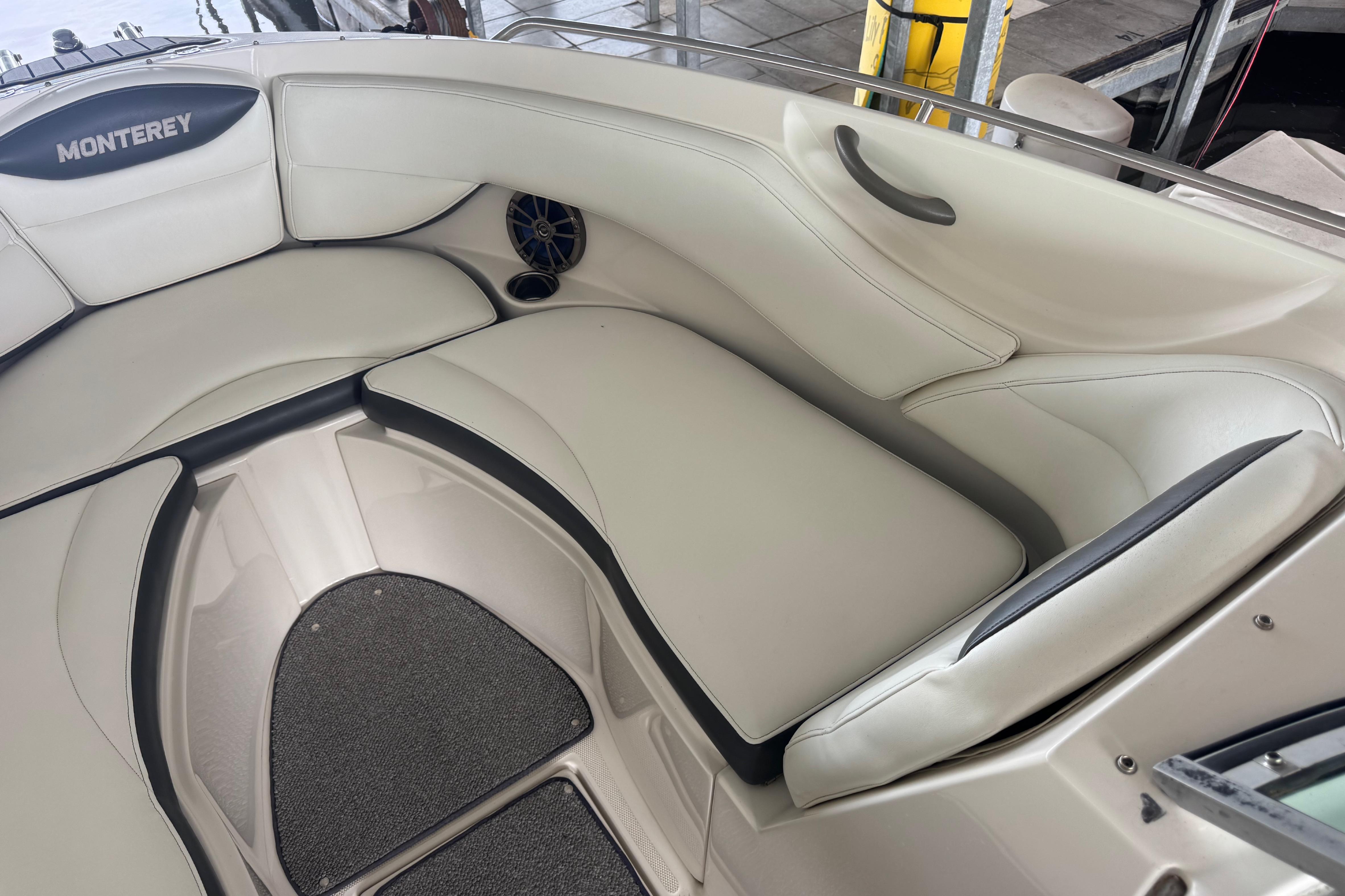 2005 Monterey 248LS Montura Bowrider interior with white cushioned seating and speaker.