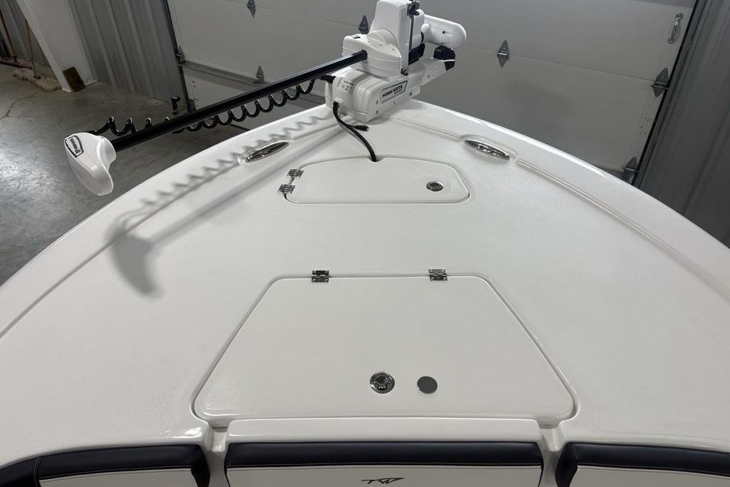 2026 Tidewater 2300 Carolina Bay boat deck with trolling motor in a garage setting.